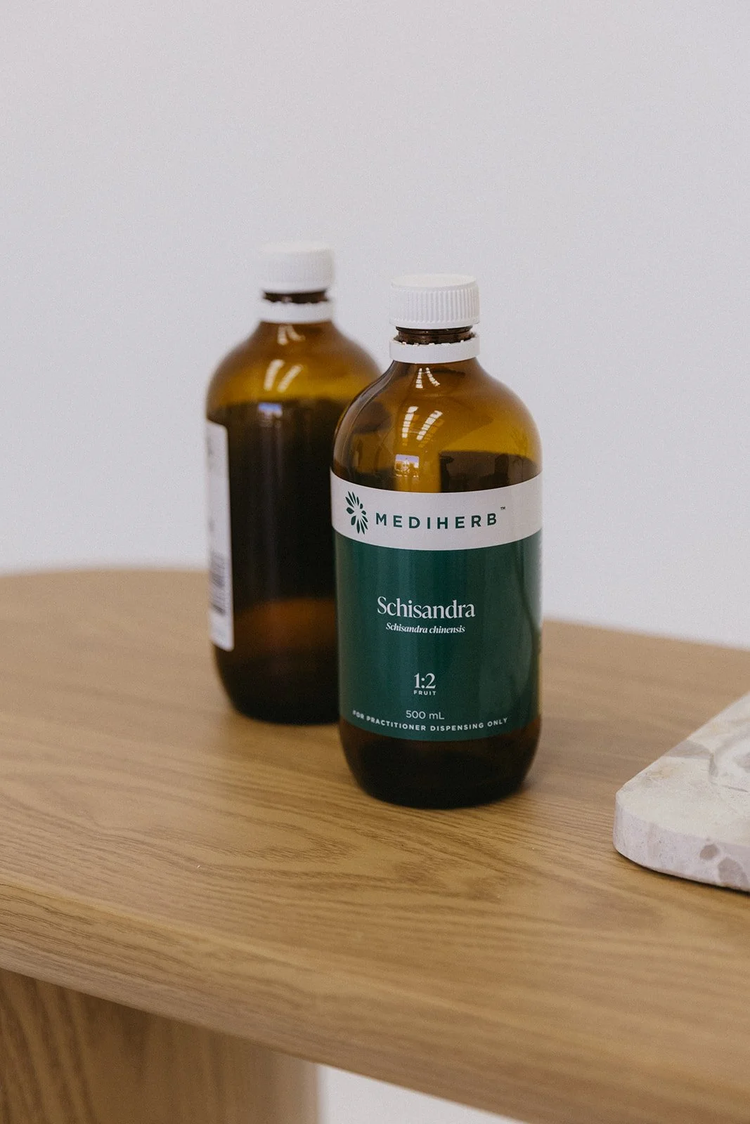 MediHerb Schisandra and herbal supplement bottles used in naturopathic treatment plans for hormonal health