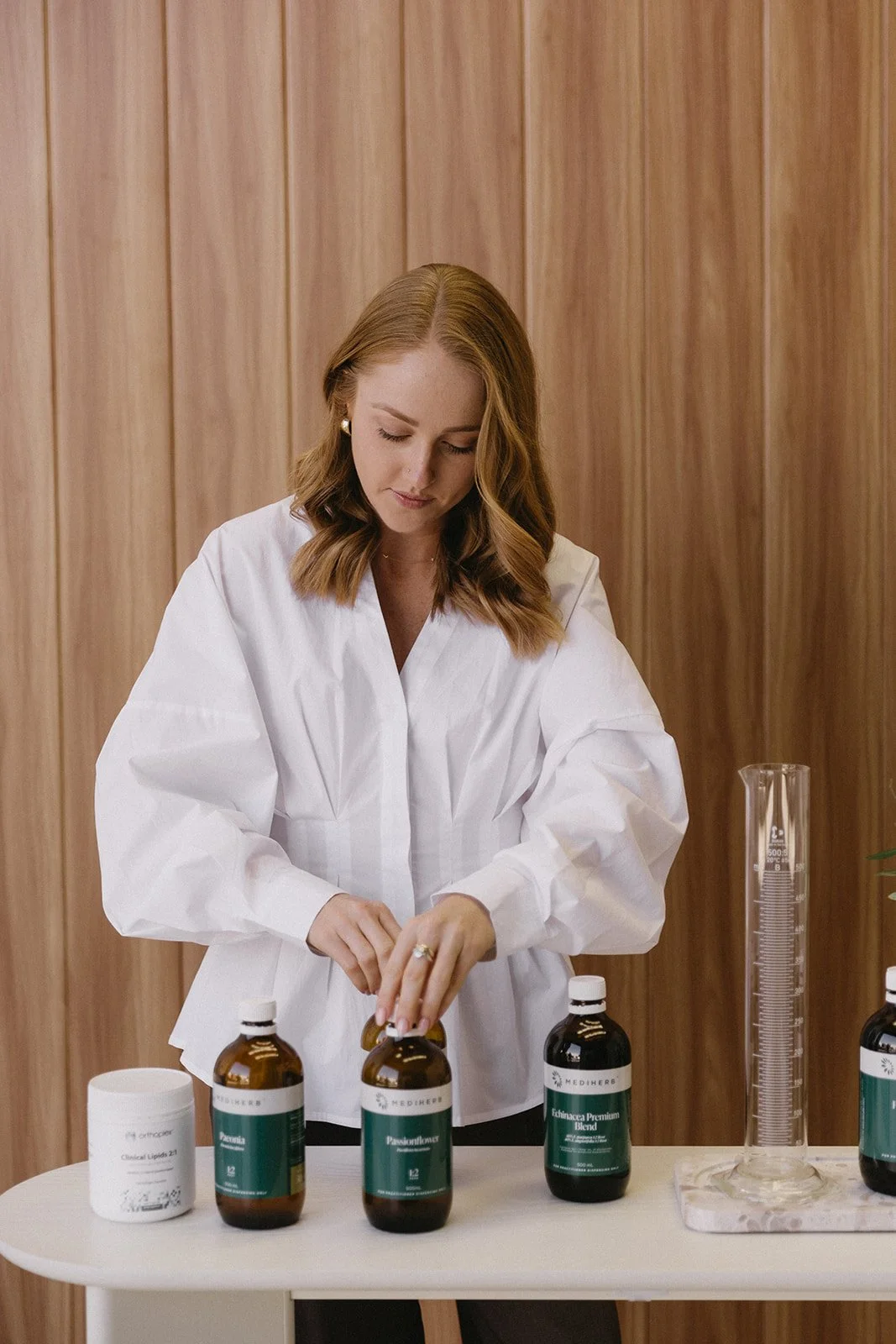 Women's health naturopath preparing herbal supplements in her online naturopathy clinic