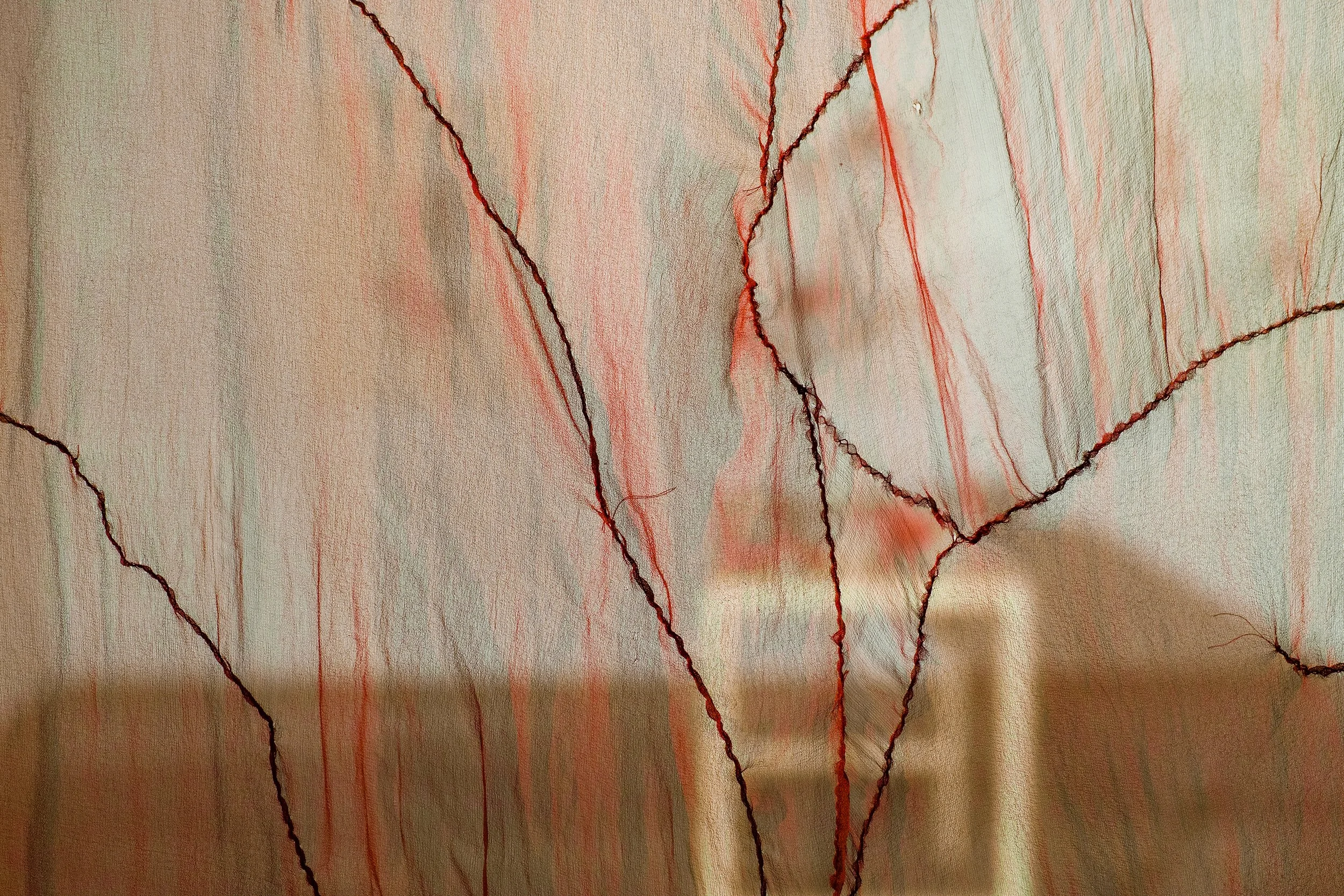 Close up of translucent red silk fabric.