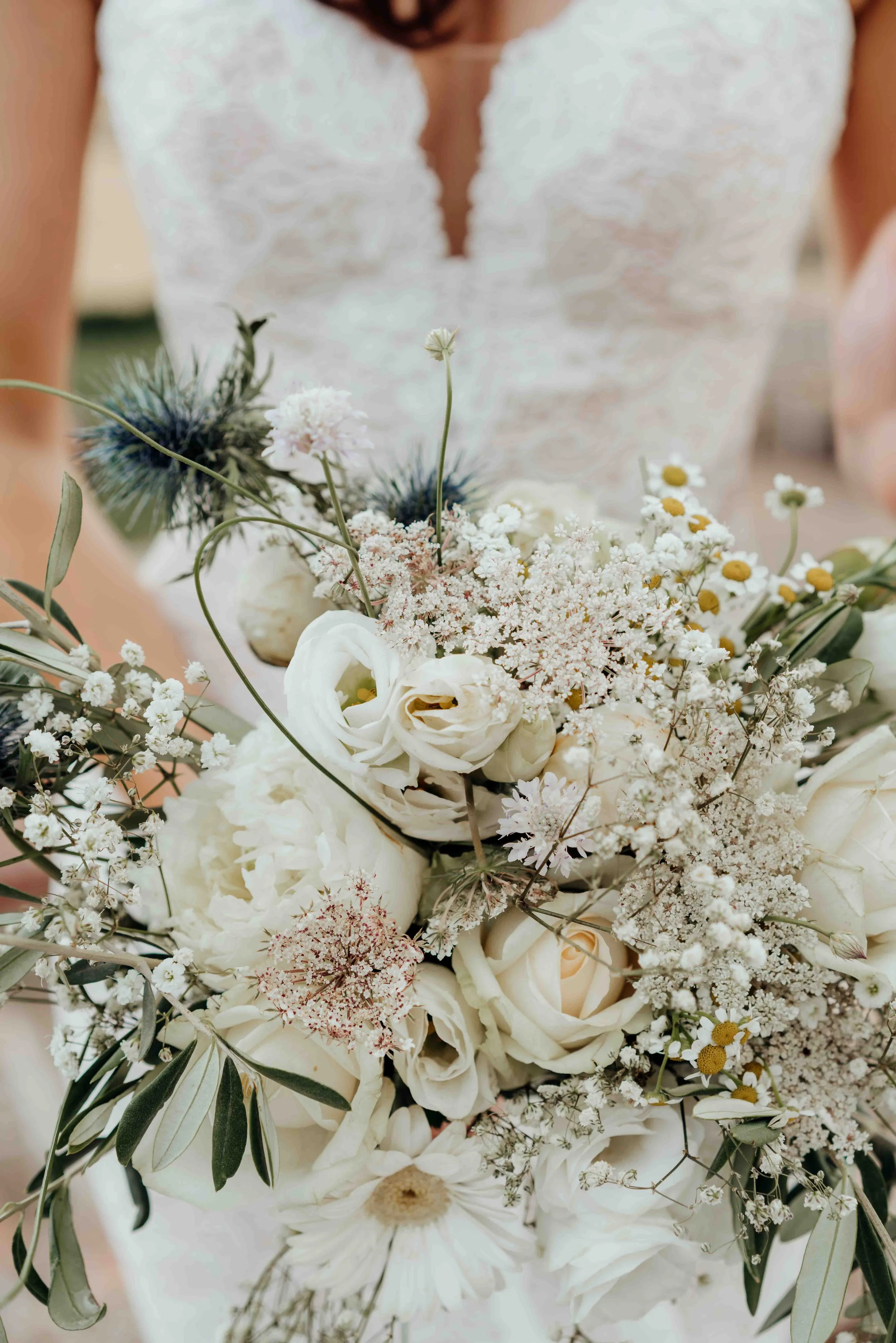 A unclose shot of a bride holding a bouquet.