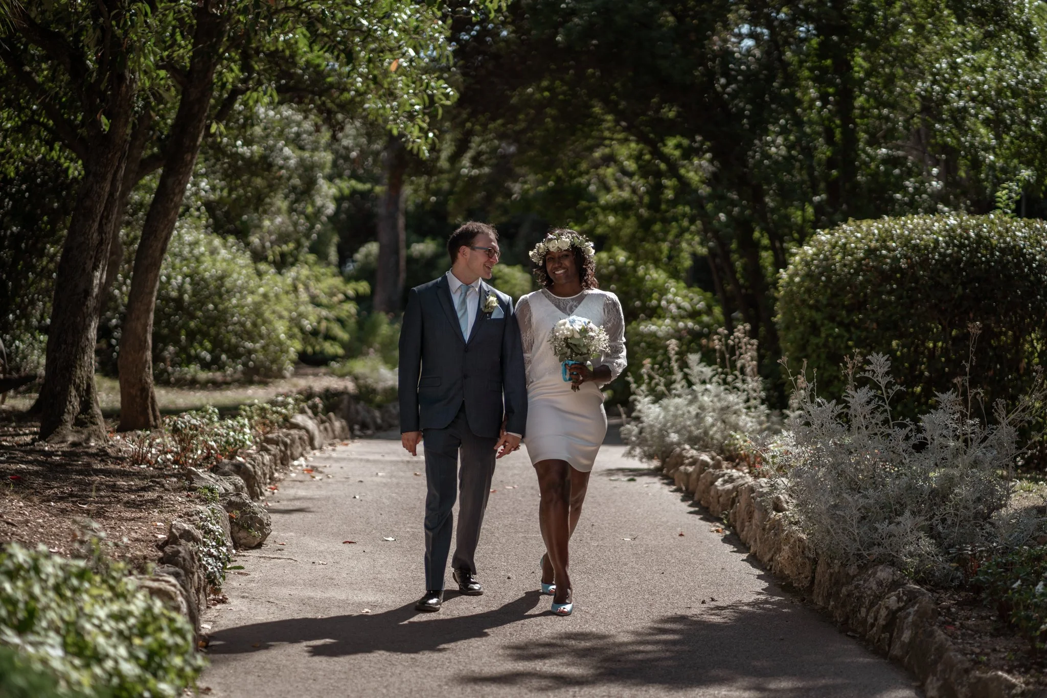 Stephanie and Jeremy walking in a park right after their wedding