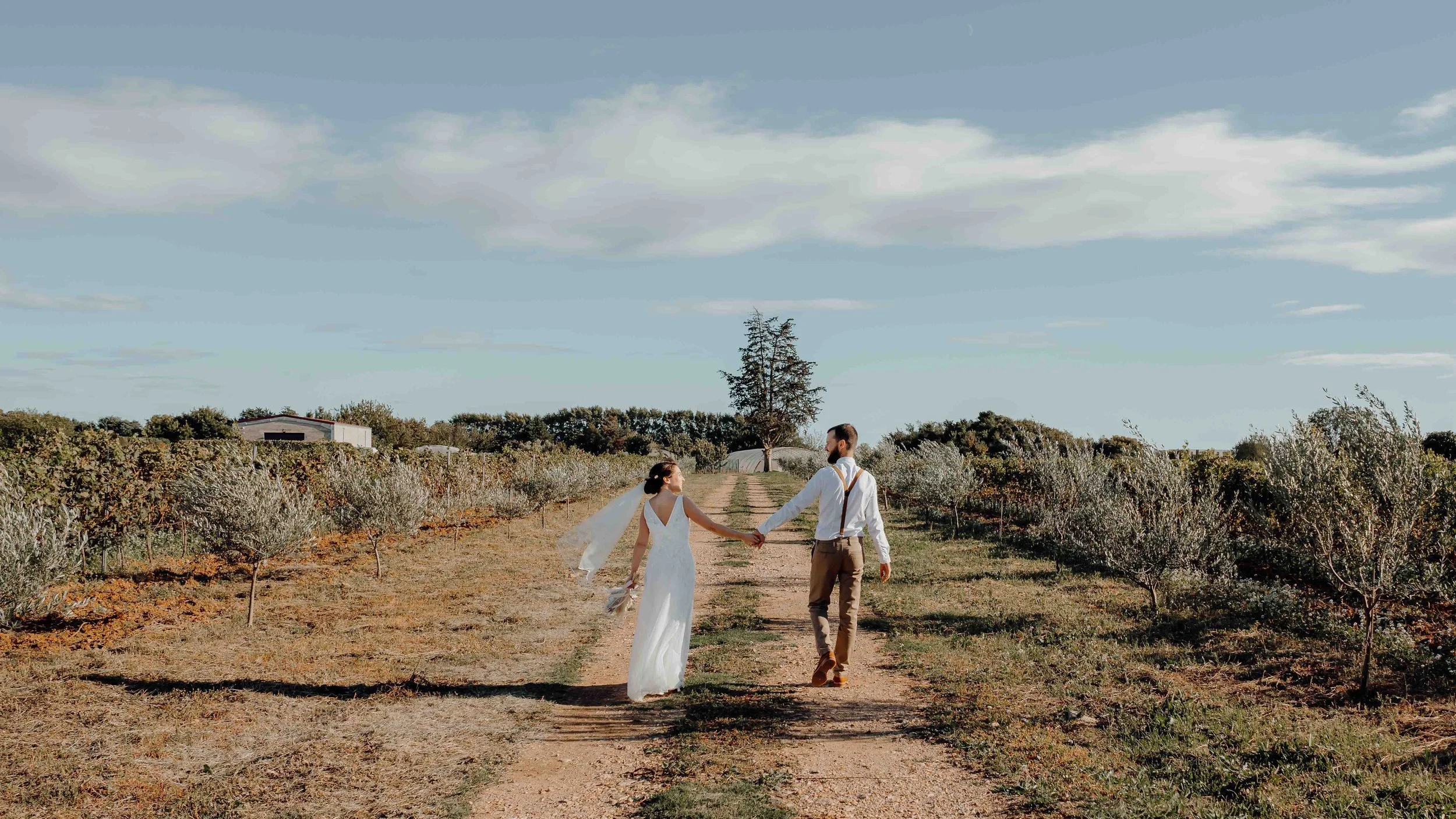 Diane & Stephane walking in a French vindyard.