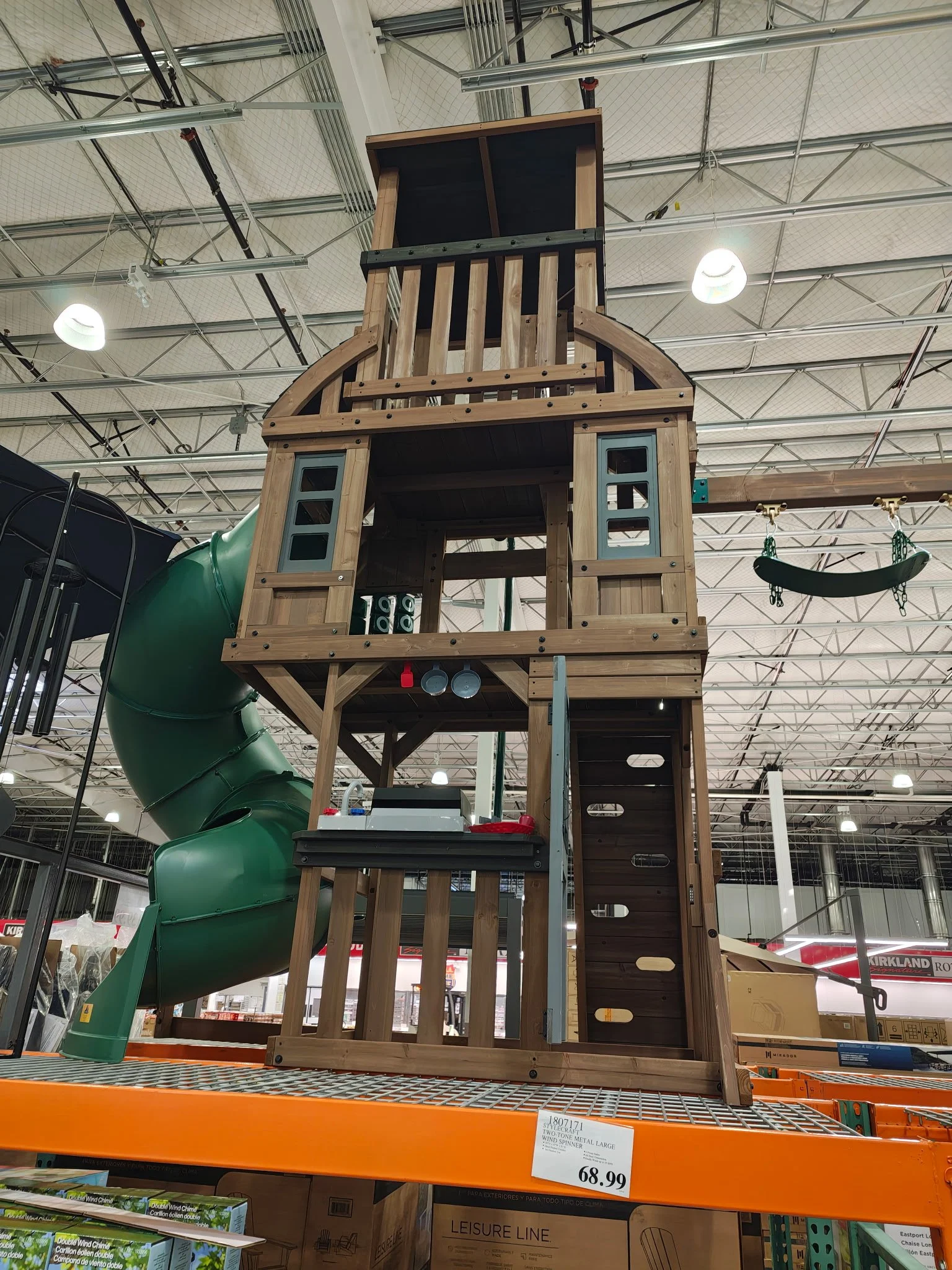 Indoor multi‑level wooden playground with a spiral slide and climbing features.