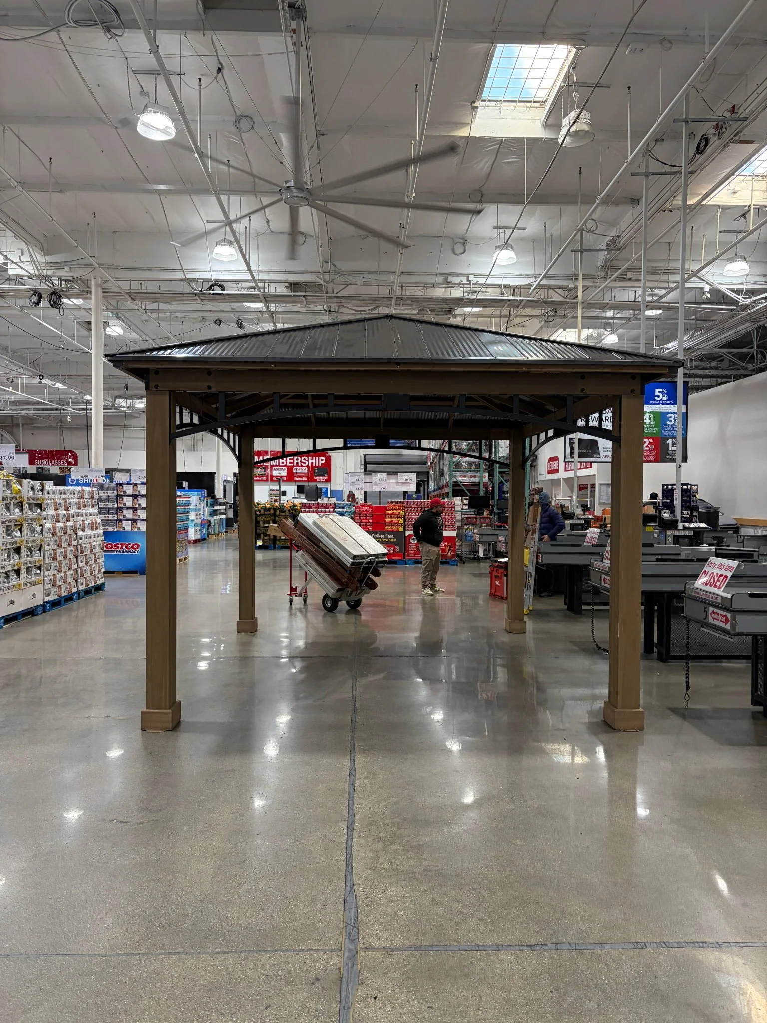 Large gazebo structure displayed inside a warehouse-style store.