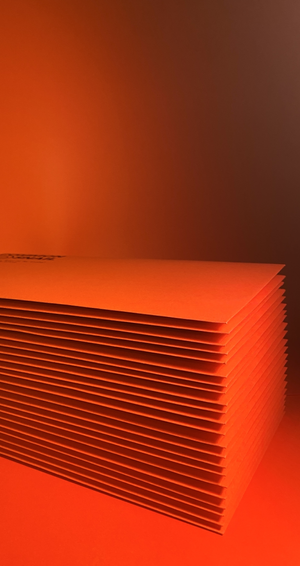 Stack of red orange envelopes.