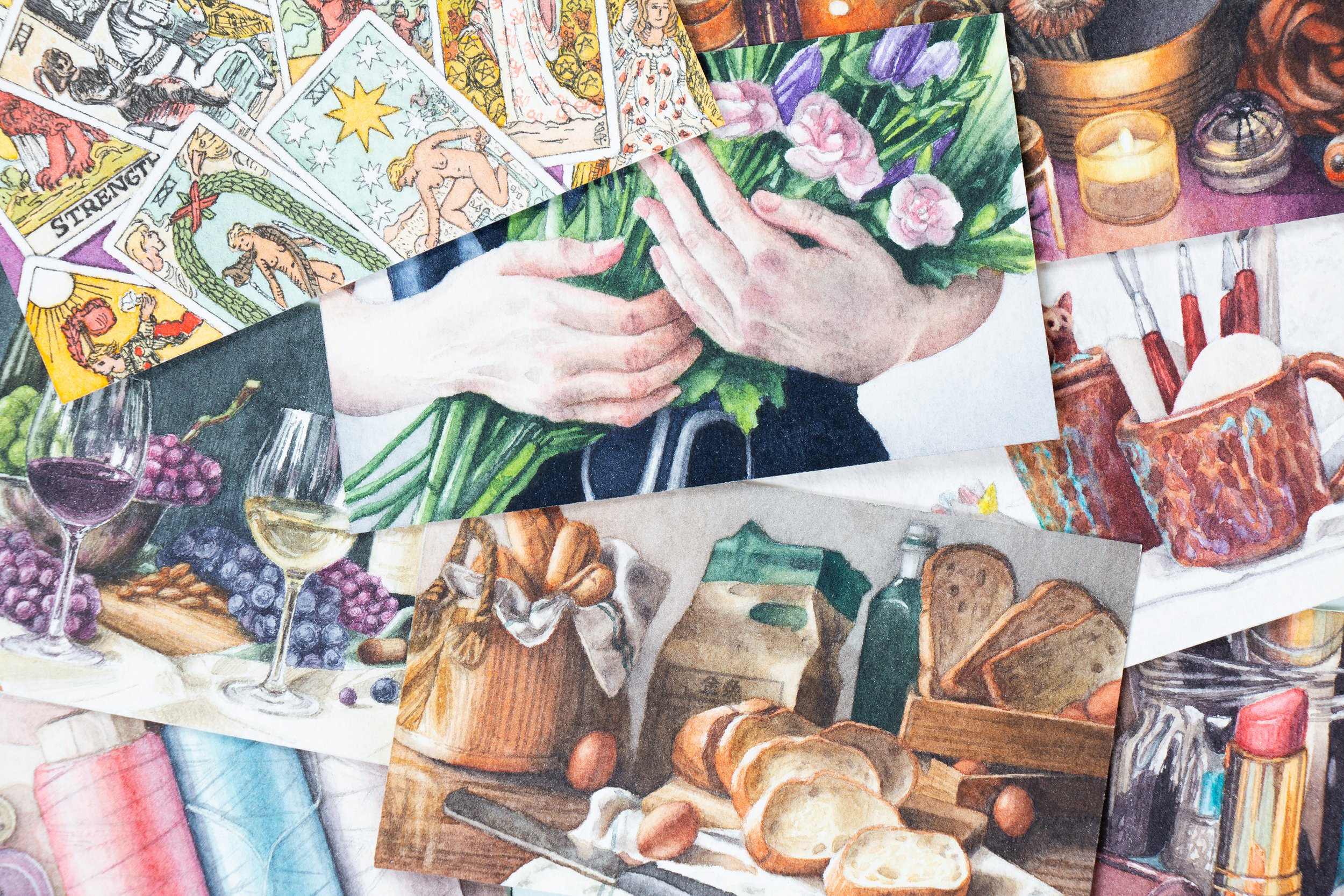 Assorted watercolor paint sketches of tarot cards, flowers, wine, grapes, and kitchen items layered together