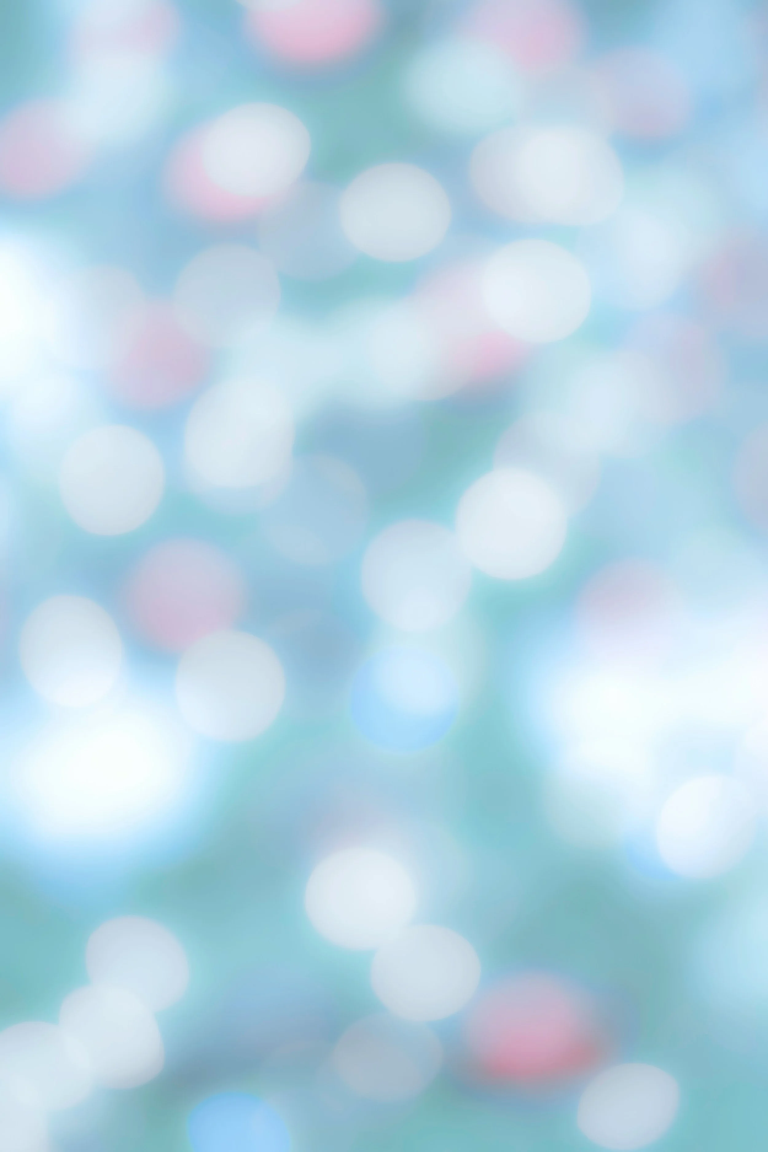 A blurred background with pastel-colored circles of light creating a bokeh effect.