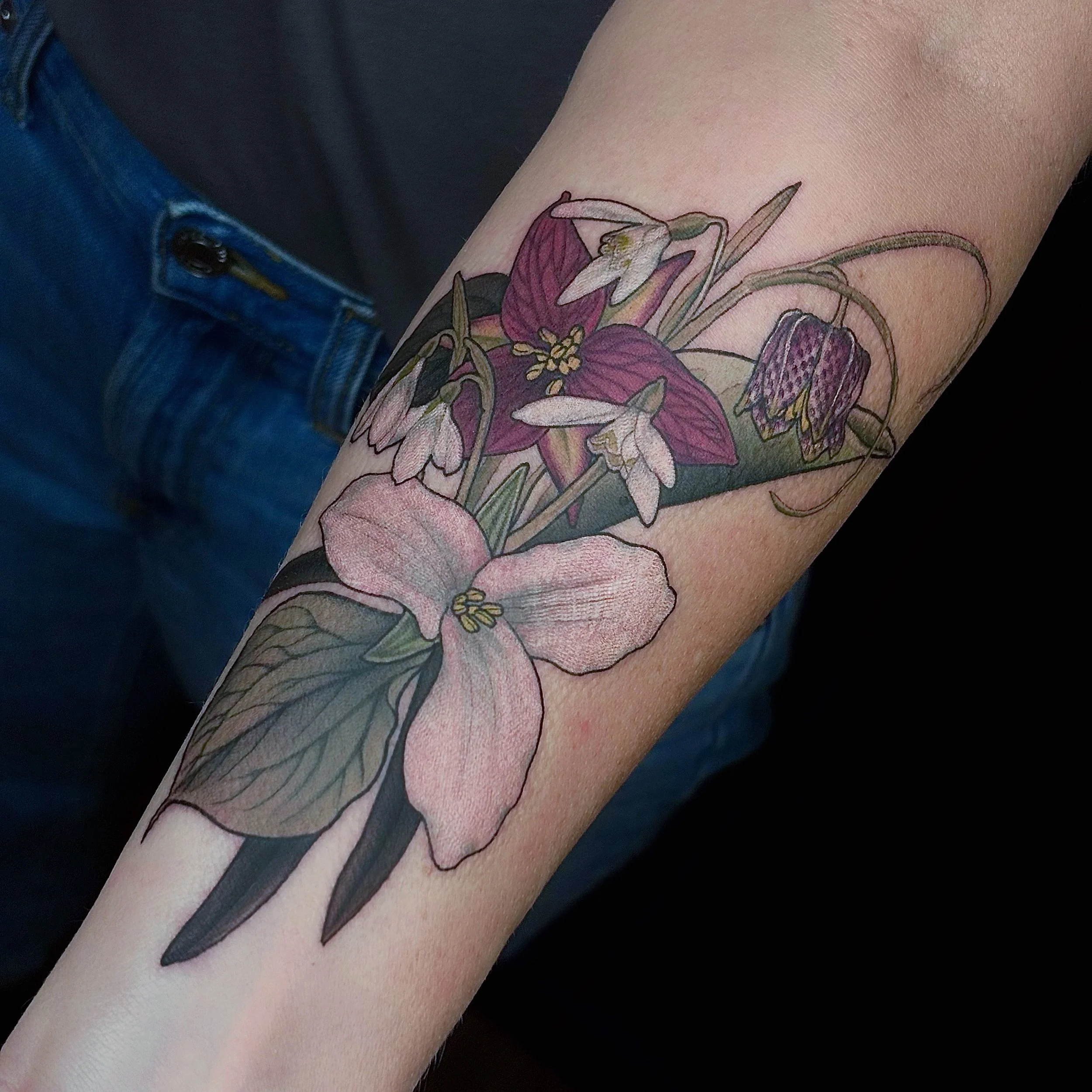Colorful floral tattoo on forearm