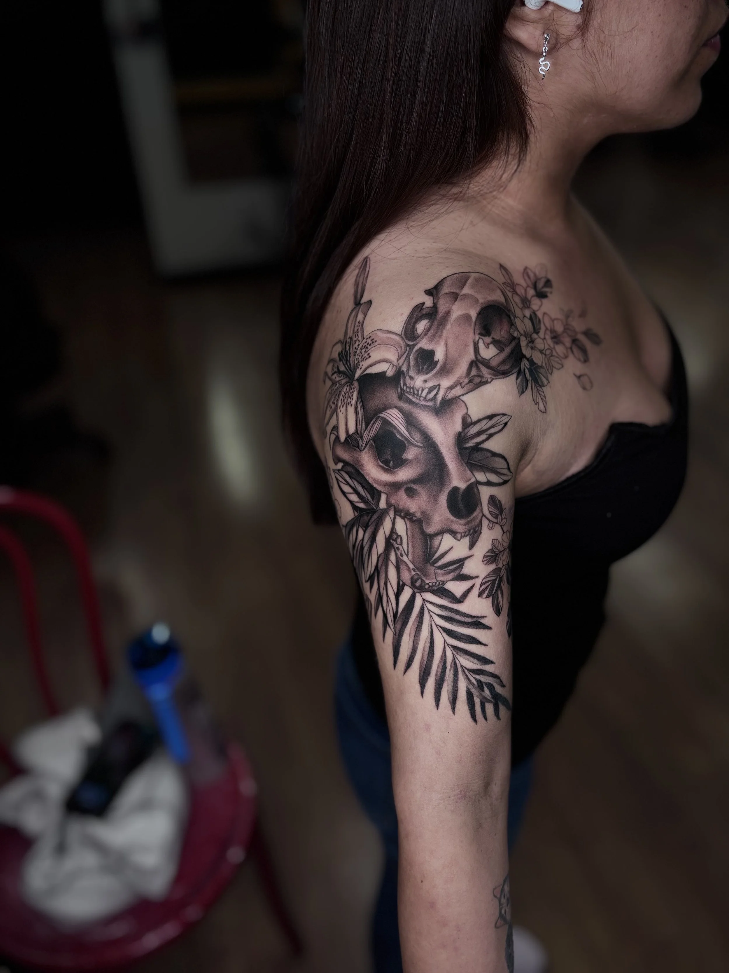 Black and gray illustrative woman portrait tattoo on upper arm