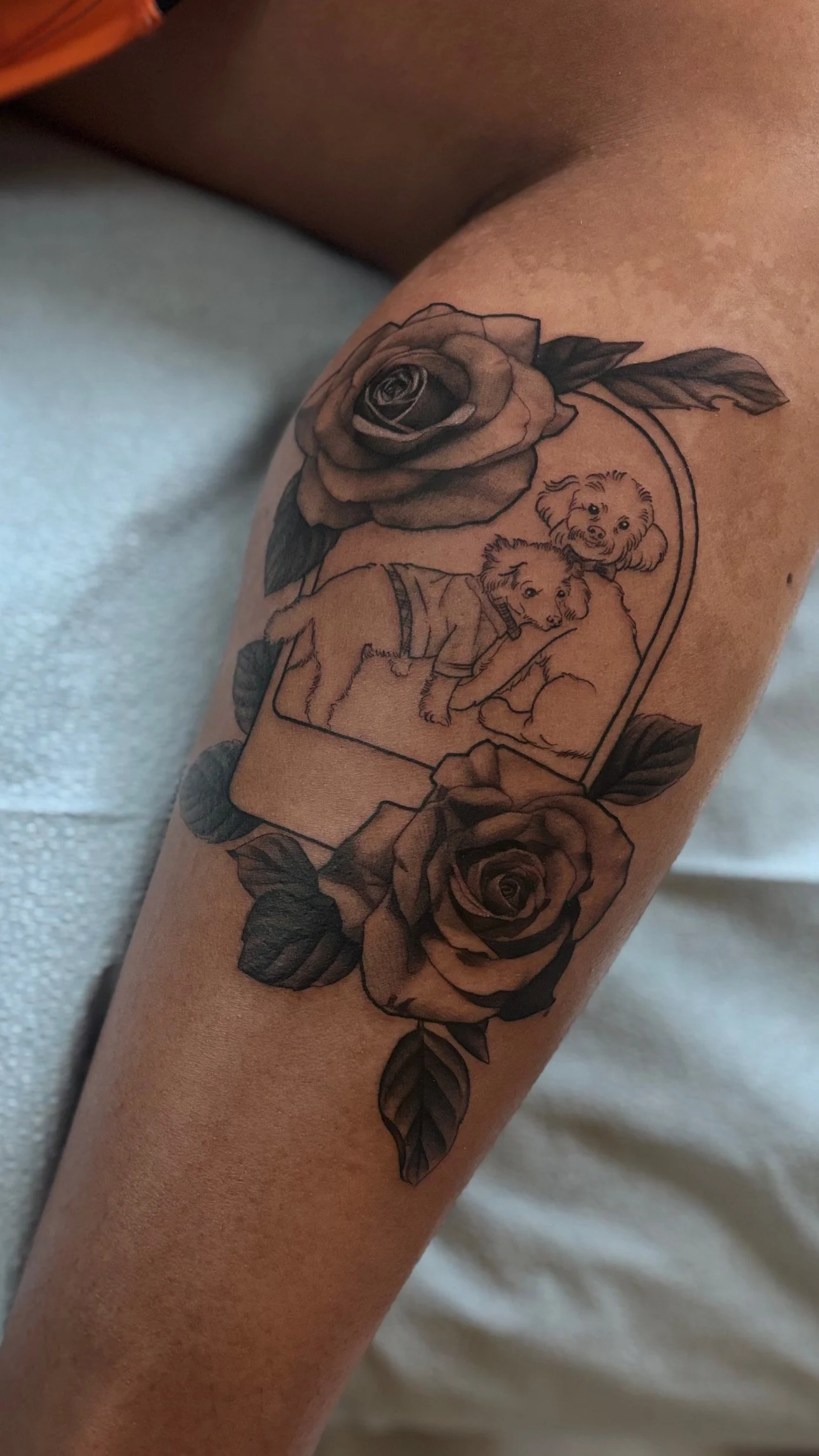 Black and gray floral tattoo on upper arm
