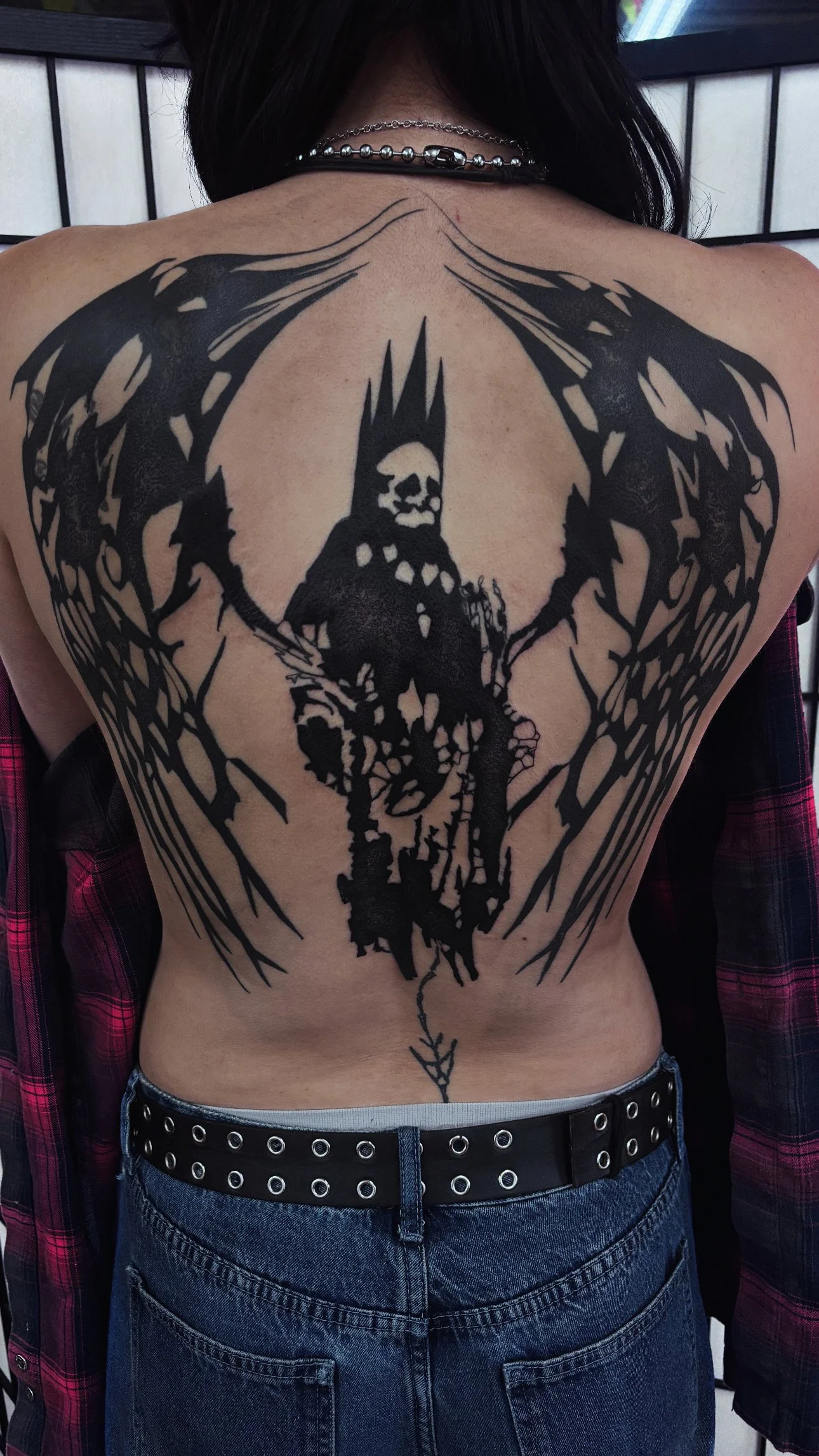 Blackwork illustrative back tattoo
