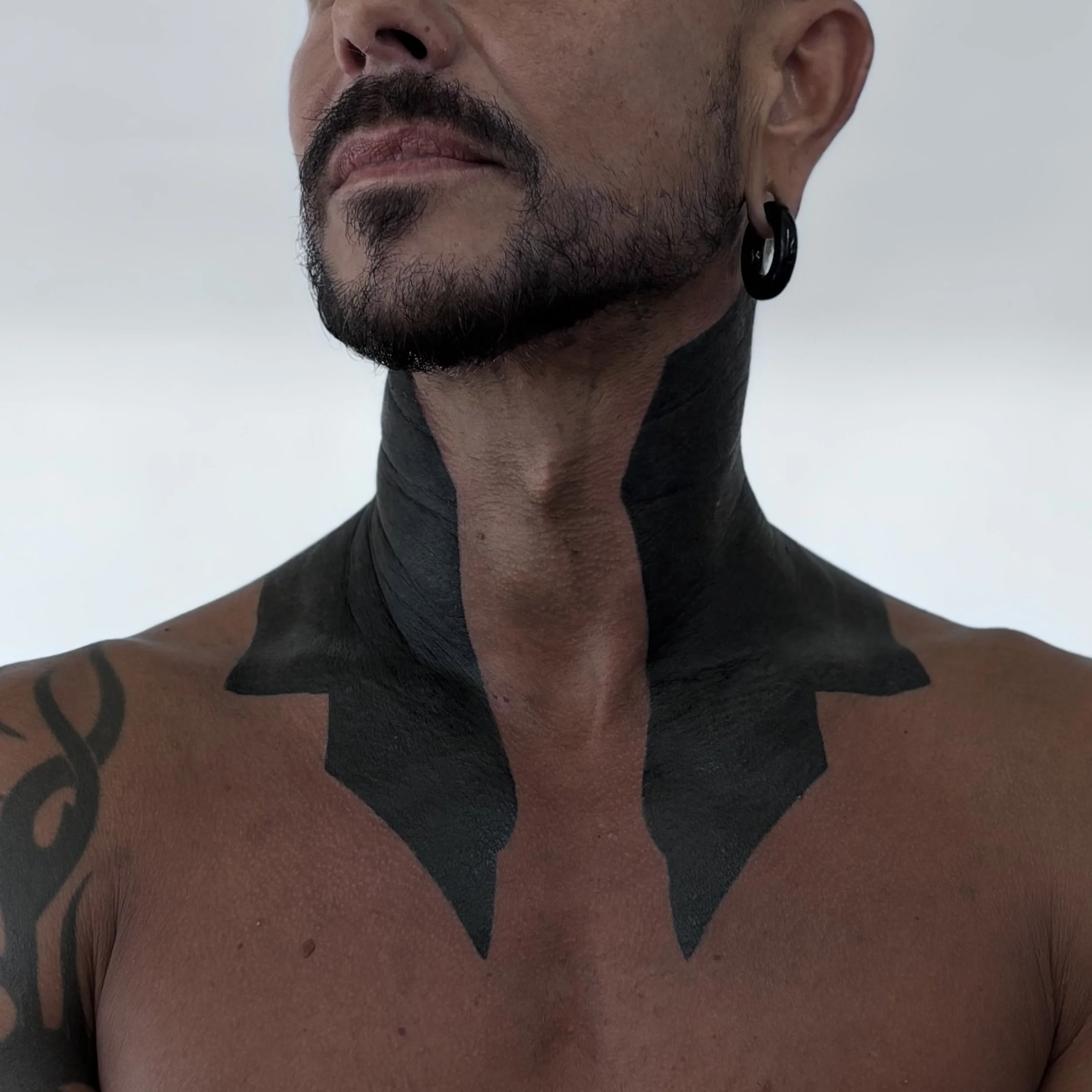 Blackwork ornamental neck and shoulder tattoo