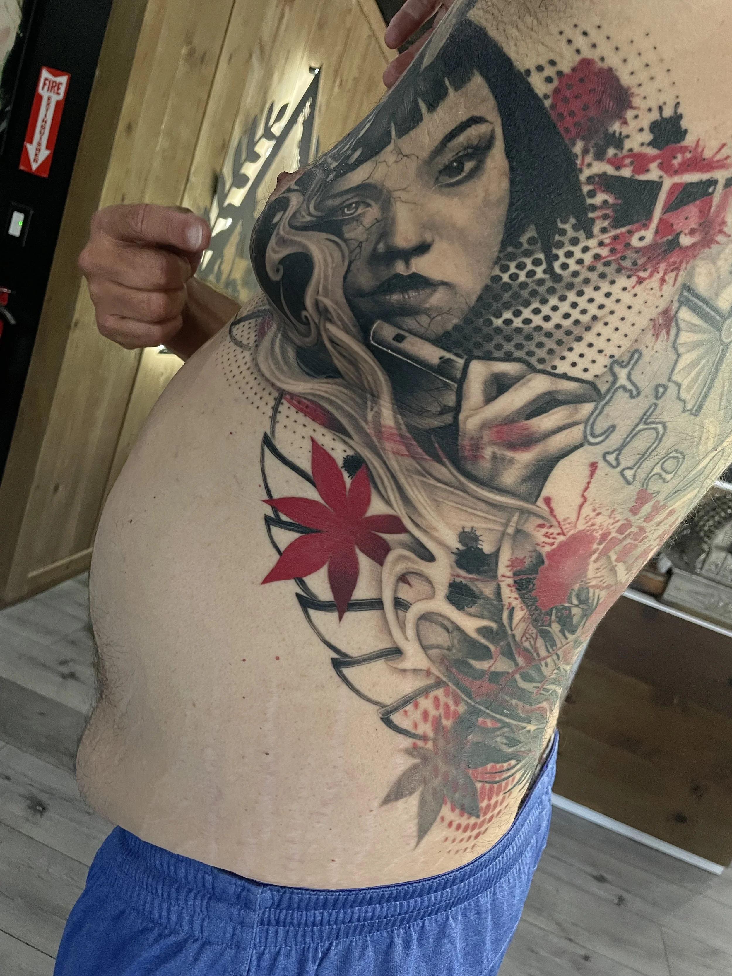 Colorful woman portrait tattoo on ribs