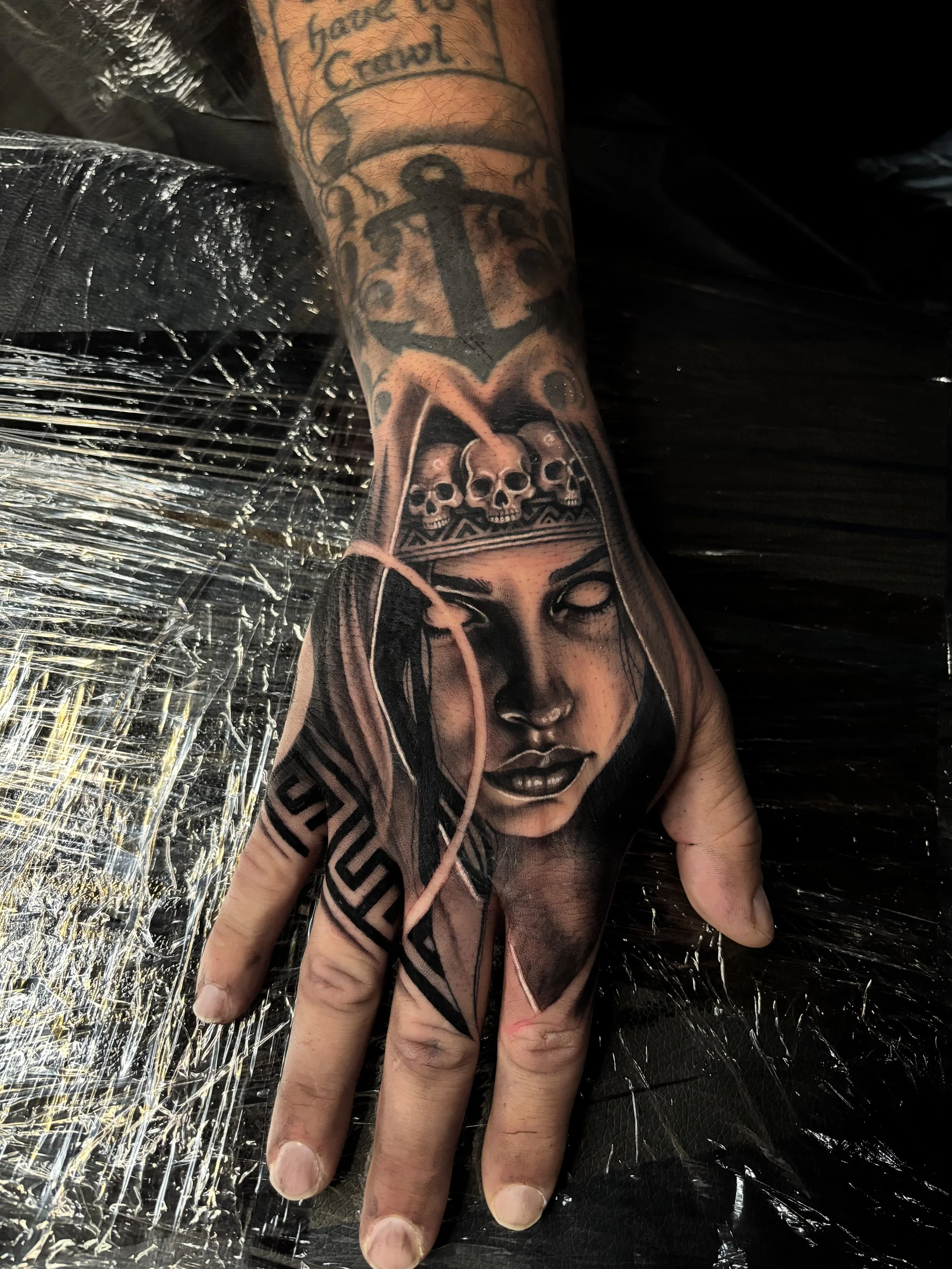 Black and gray woman portrait tattoo on forearm
