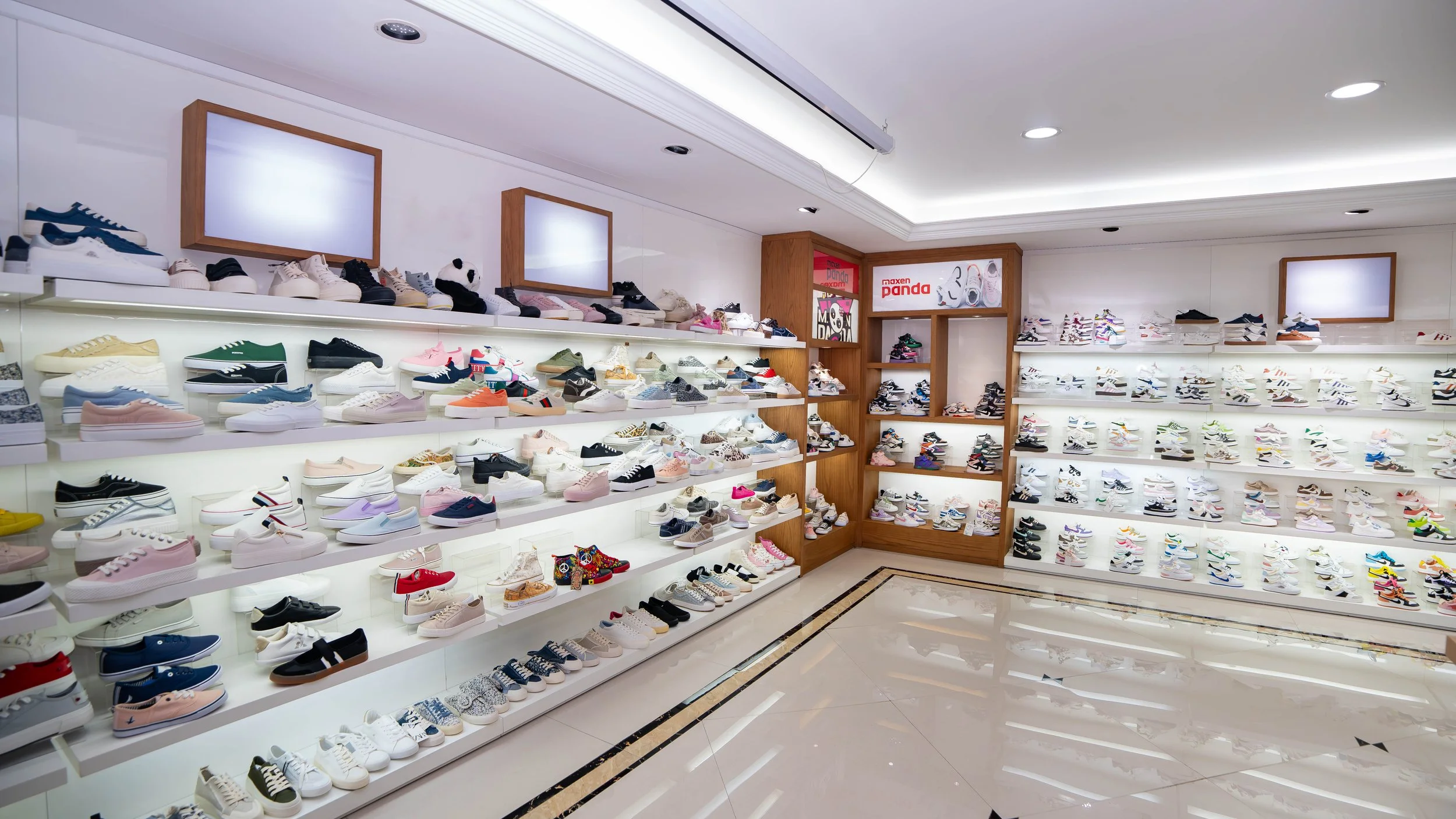 Inside a shoe store with shelves filled with various sneakers in different colors and styles.
