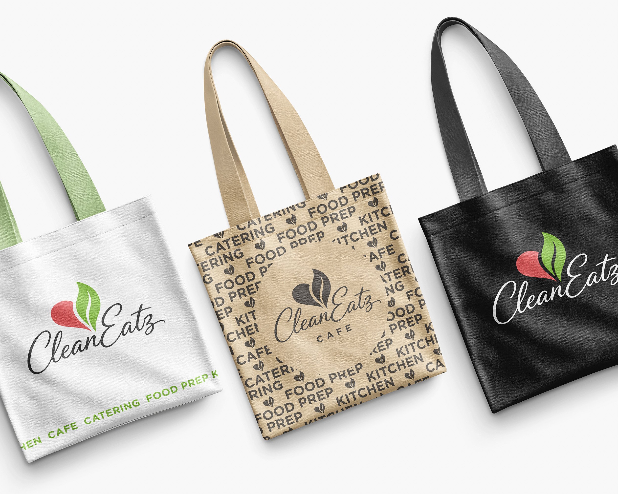 Three reusable tote bags in green, white, beige, and black, with branding and text related to catering, food prep, and kitchen, displayed at an angle against a white background.