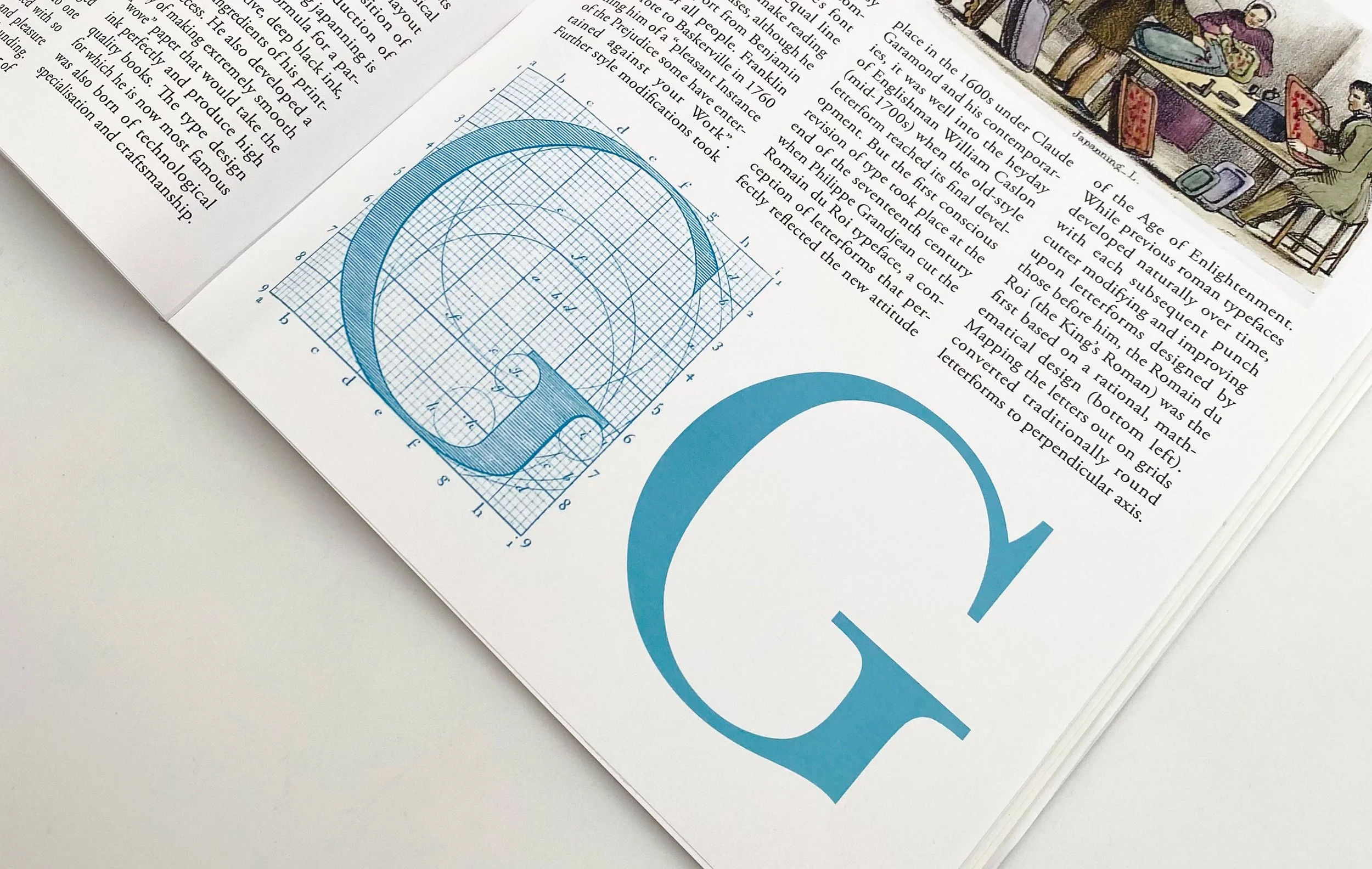 An open book showing a blue geometric diagram on one page and text on the other, with a partial illustration of people sitting at a table in the upper right corner.