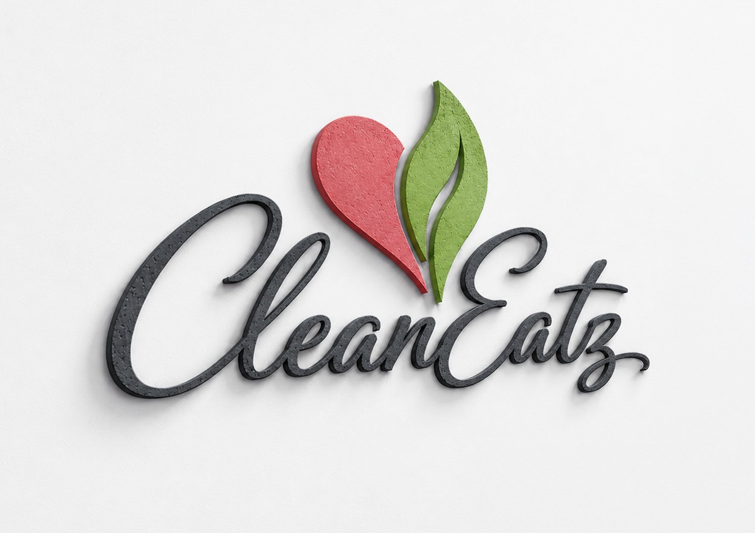 A decorative three-dimensional sign with the word 'CleanEatz' in black cursive lettering, featuring a heart and leaf logo above the text against a white background.