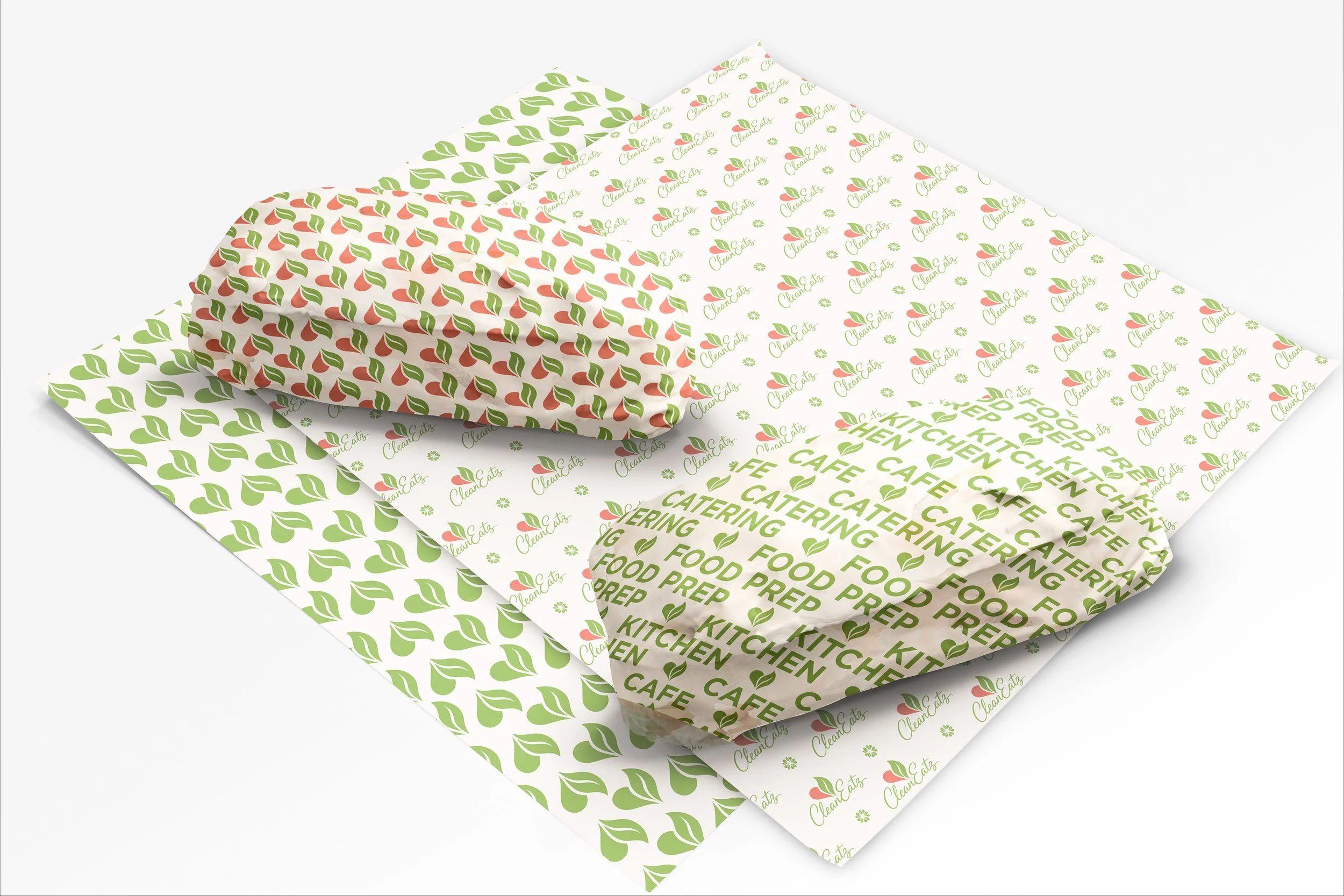 Three sheets of printed paper with repeating patterns and words related to a kitchen, food, and catering, featuring a logo with a leaf and the text 'Clean Cats'.