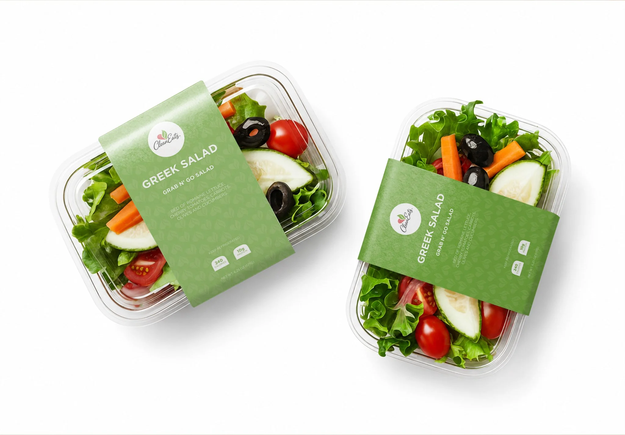 Two containers of Greek salad with fresh vegetables like cherry tomatoes, cucumbers, carrots, and olives, wrapped in green labels with the brand name 'CleanEatz' and salad details.