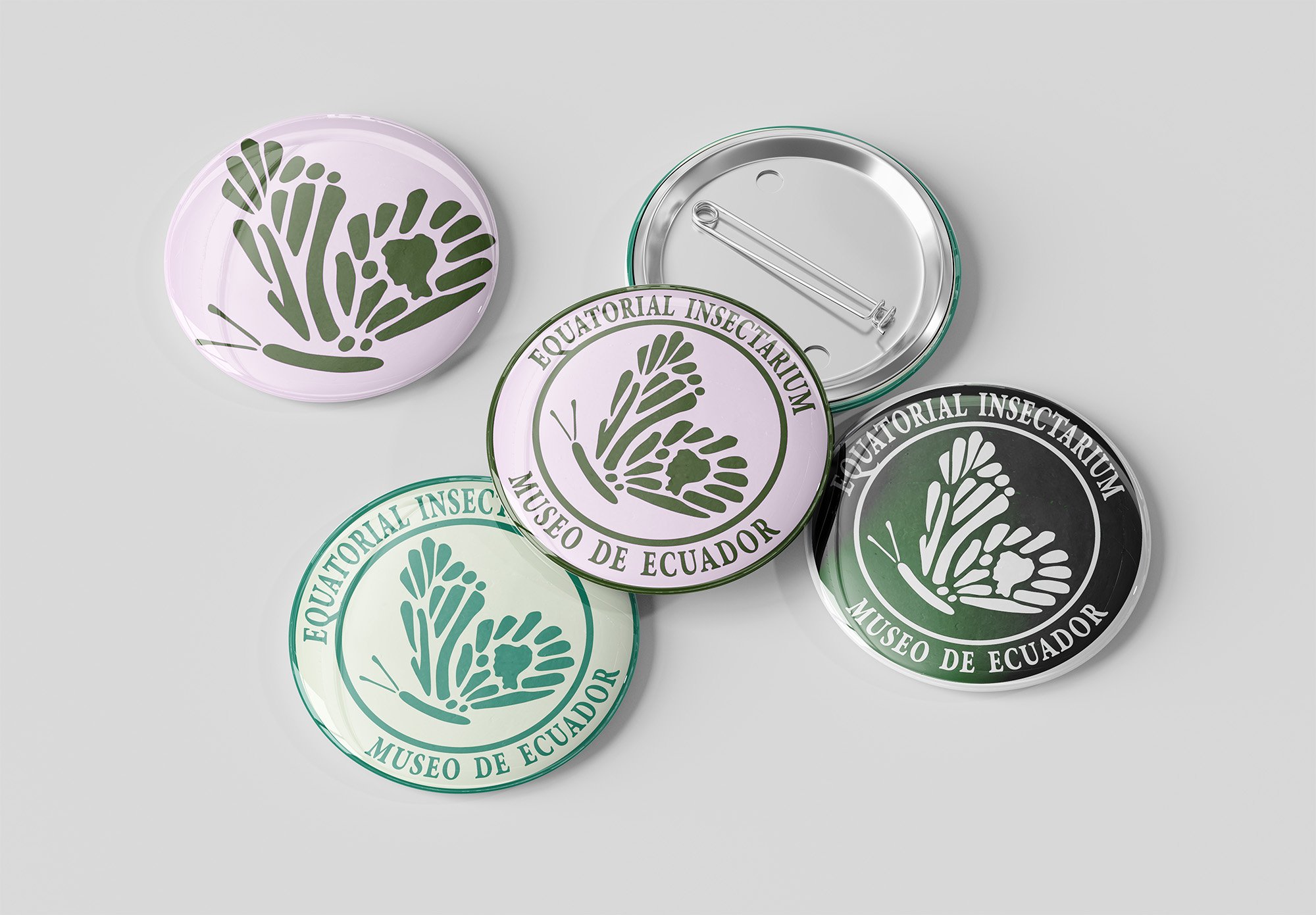 Collection of pins from the Ecuadorian Insectarium Museum featuring a green and black insect plant-like logo and the museum's name, reading  'Equatorial Insectarium Museo de Ecuador'.