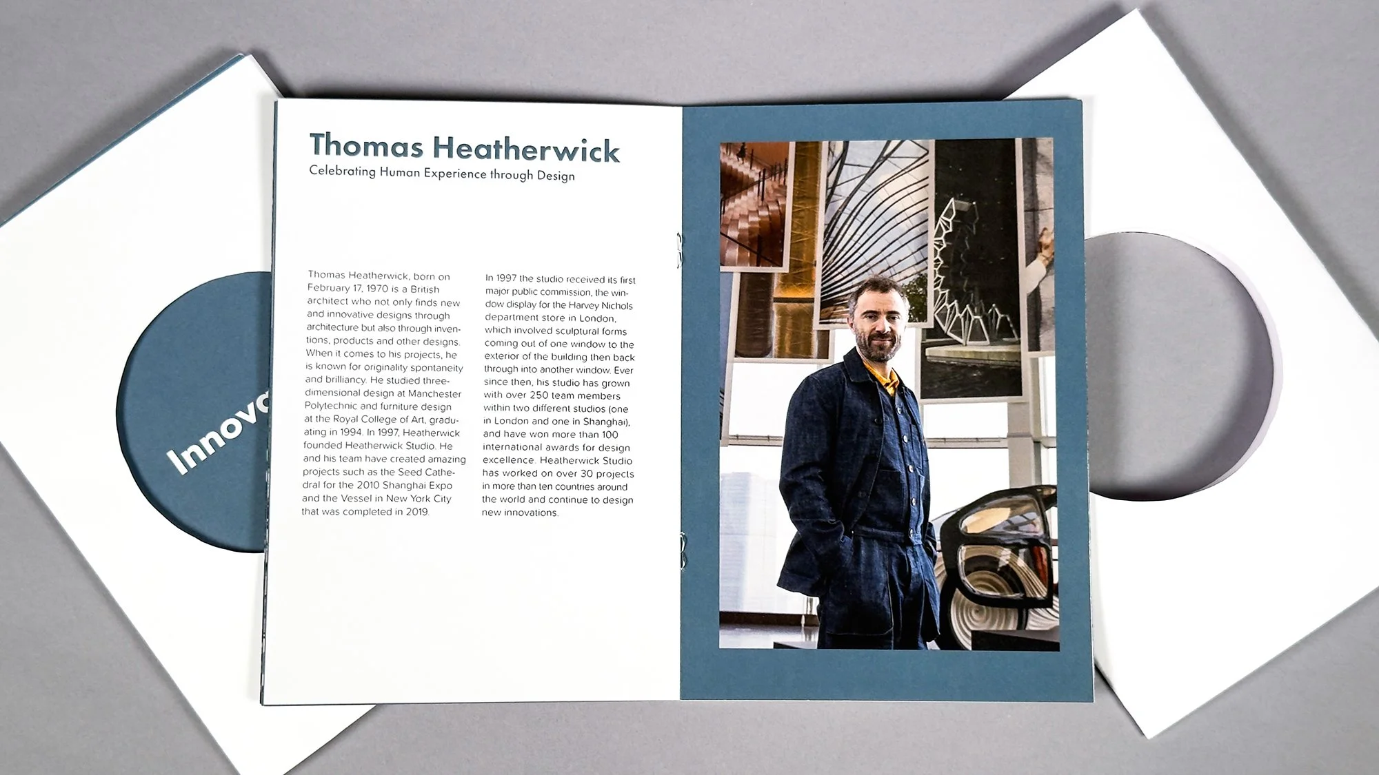 Open brochure featuring information about architect Thomas Heatherwick, including a photograph of him standing in front of architectural models and design projects.