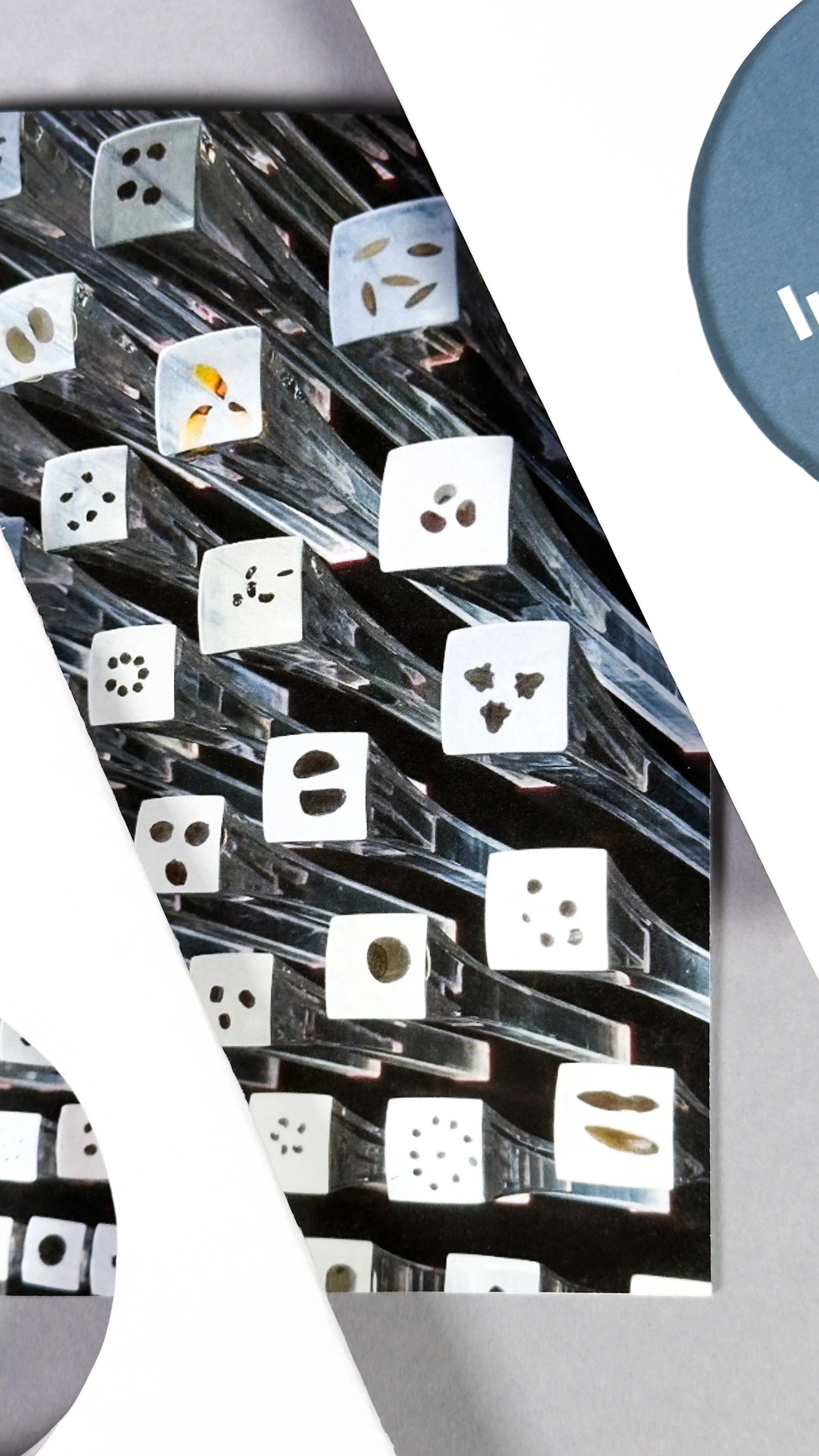 Close-up of the interior of the Seed Cathedral showing several acrylic rods with multiple small seeds in each, mounted on a metallic grid structure. On opposite sides of the image are the sides of the cut out circular covers.