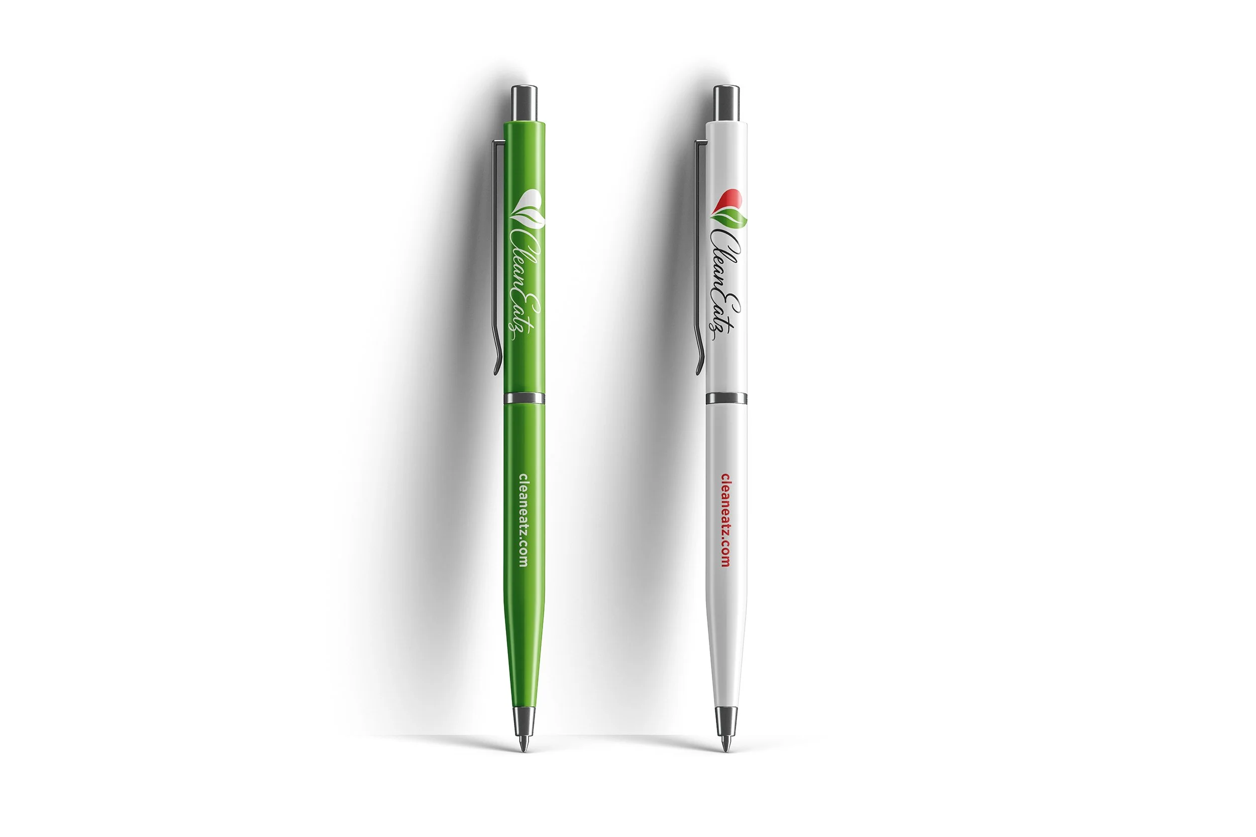Two pens, one green and one white, with 'CleanEatz' logo and website on each, positioned vertically against a white background.