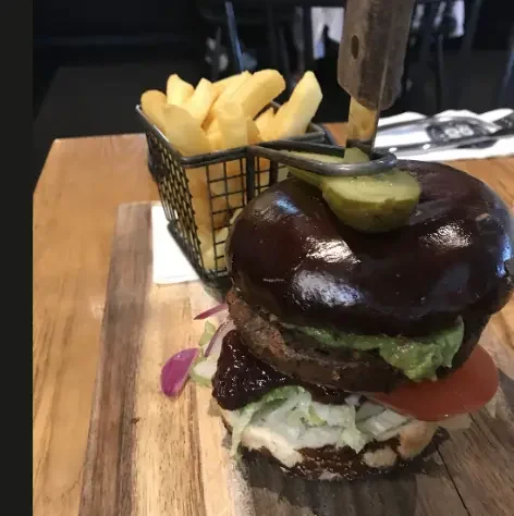 Gourmet burger with chips served at The Good Home Wigram