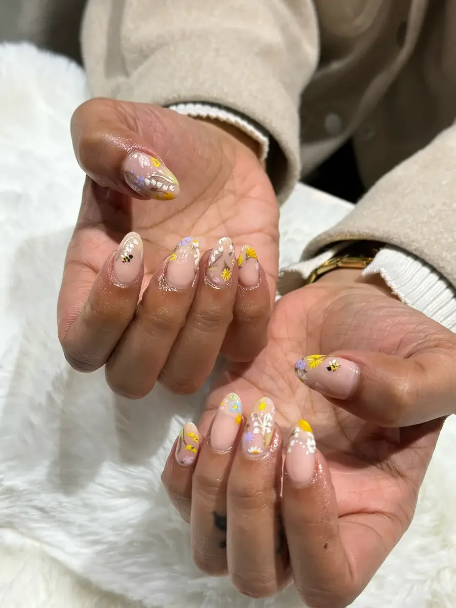 Floral nail art with yellow and white details created at Petals Nail Salon Wigram