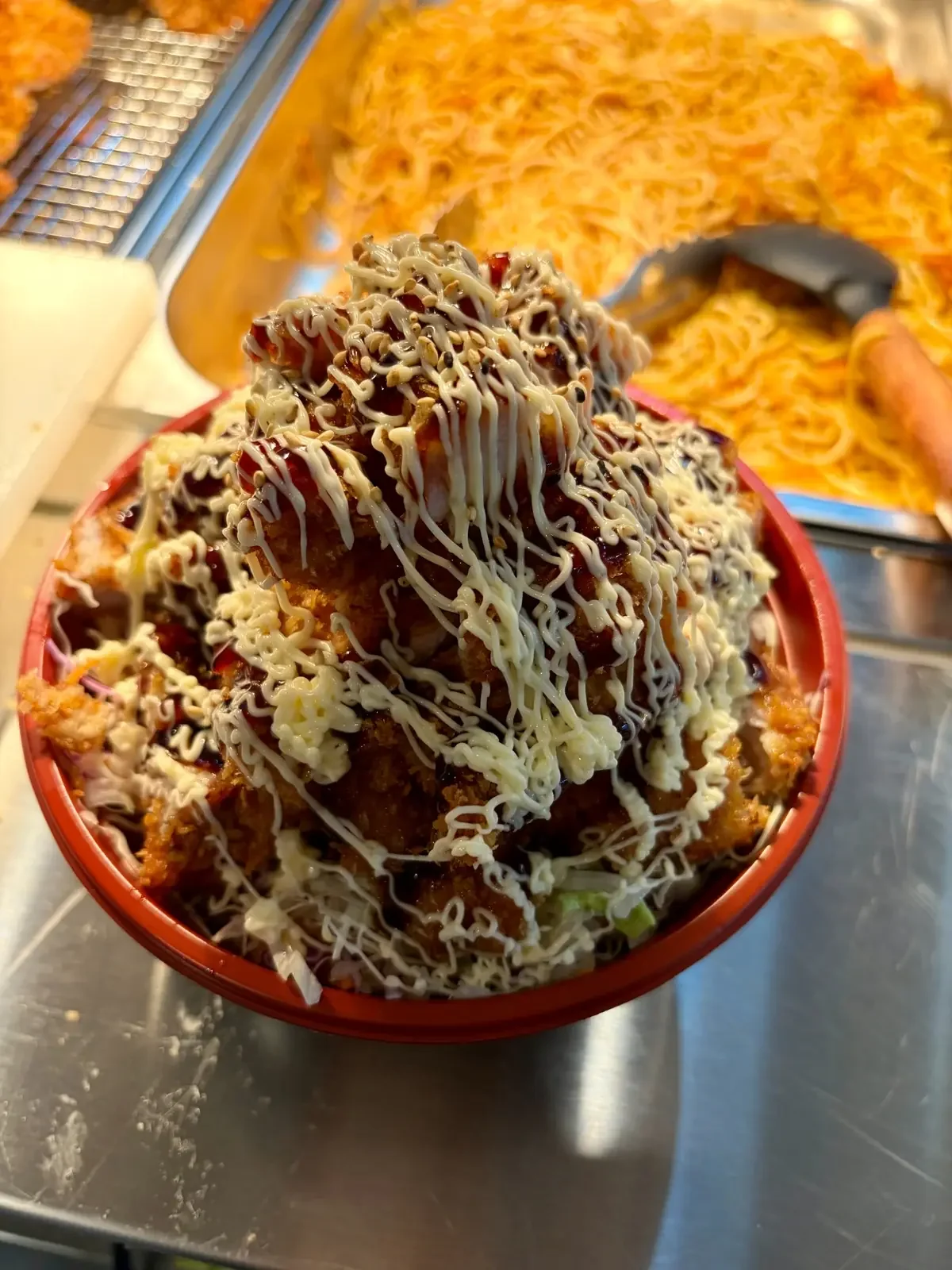 Chicken katsu bowl topped with Japanese sauce and mayonnaise at One Sushi Wigram