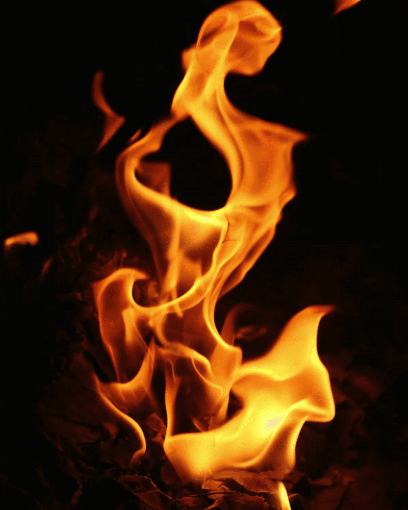 A close-up of bright orange and yellow flames against a black background, with swirling and flickering patterns.