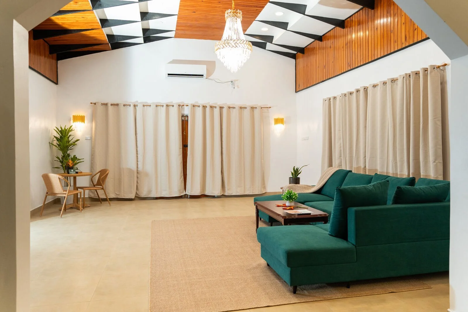 Large living room with sofa and chandelier at the Garden Flat in Nakasi, space for a group of six to relax together