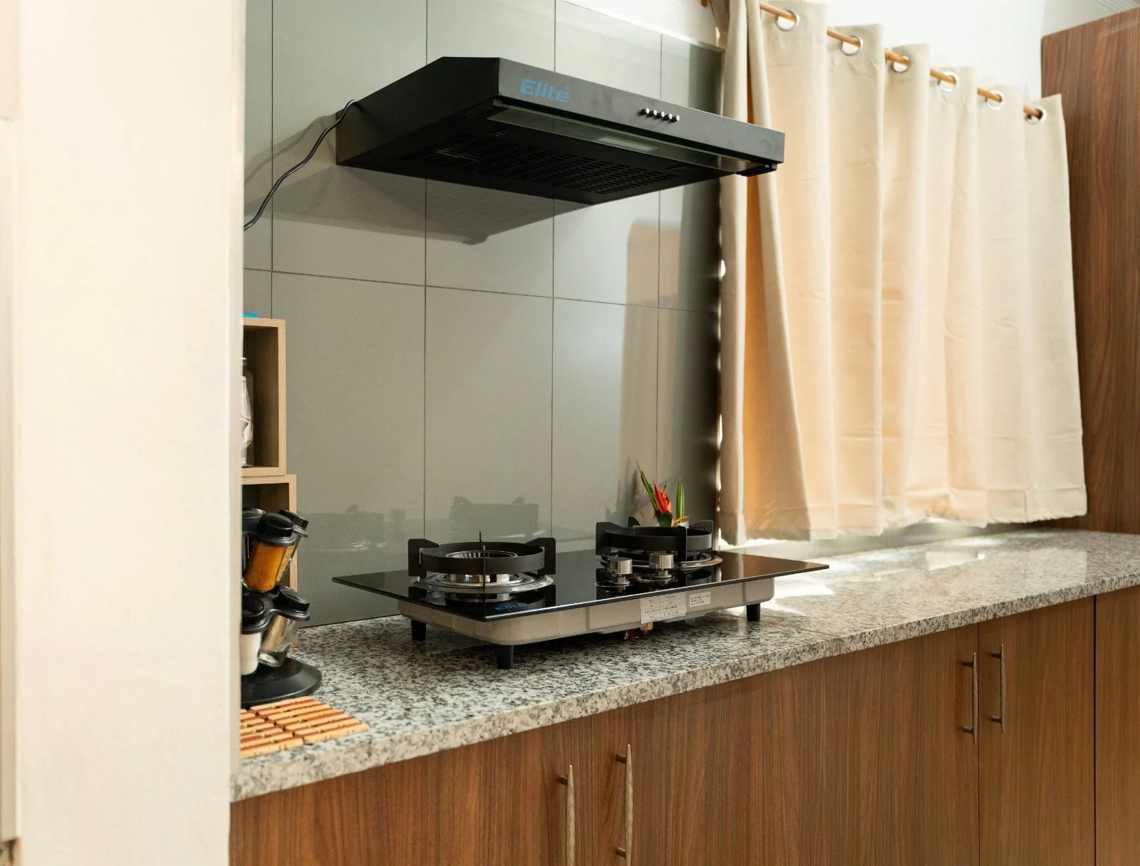 Kitchen with gas stove and granite benchtop at the Garden Flat, Nausori