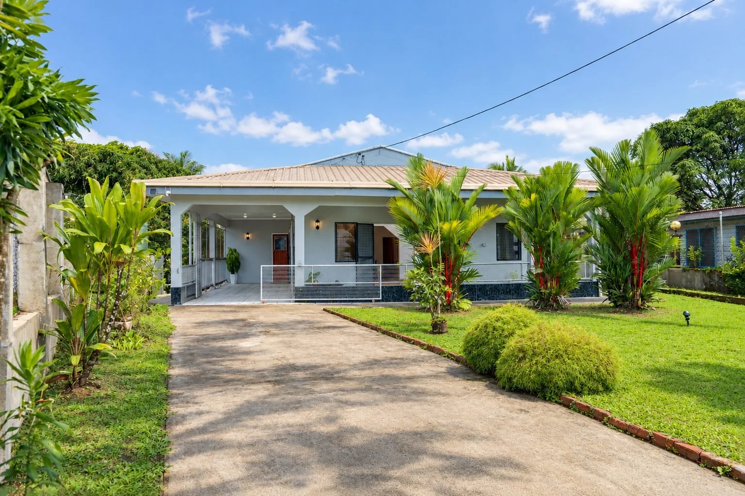 Front garden with palms and lawn at SPACES Fiji, 11 Buli Road, Nakasi, Nausori