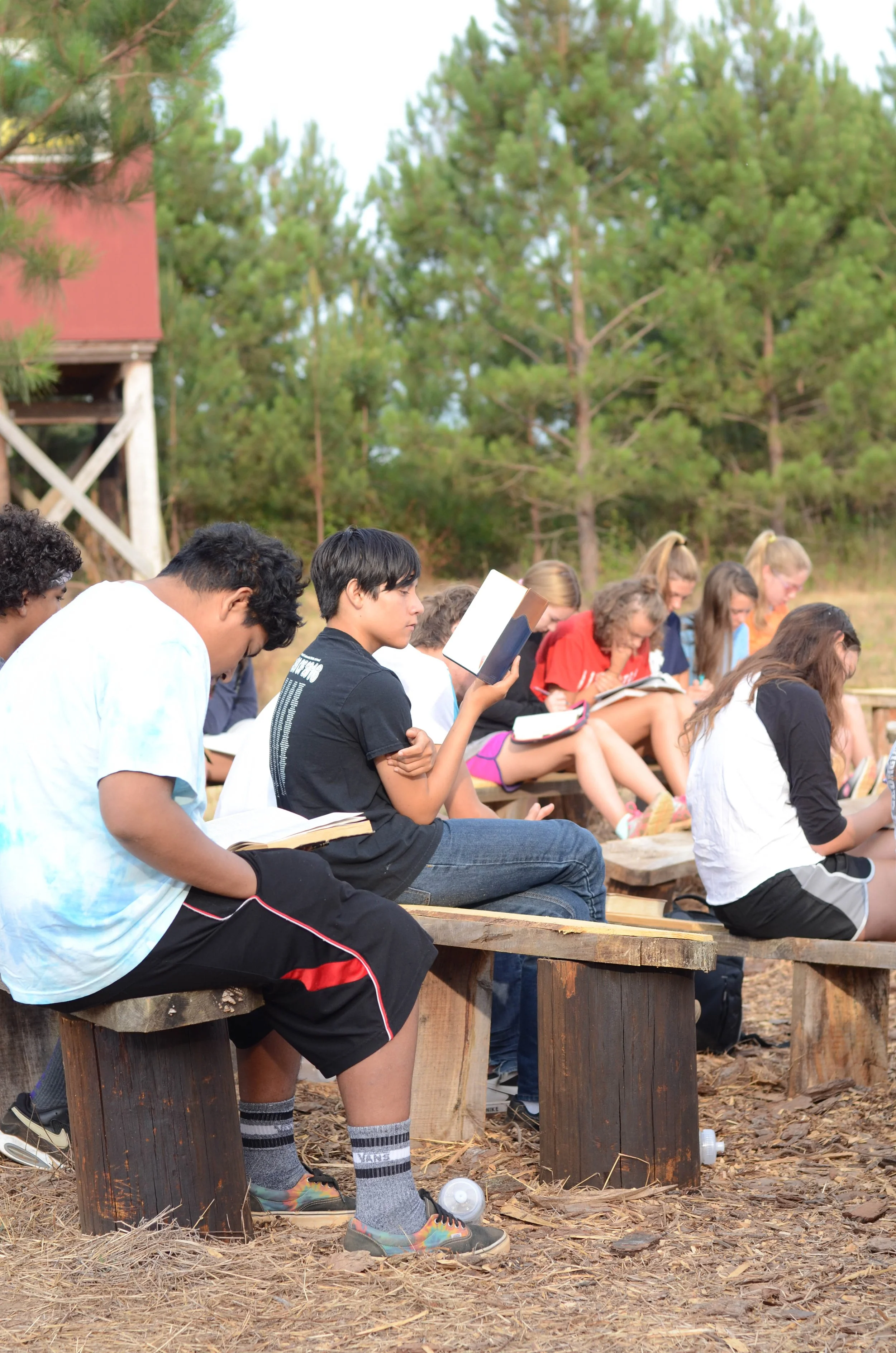 Group bible outside by the fire