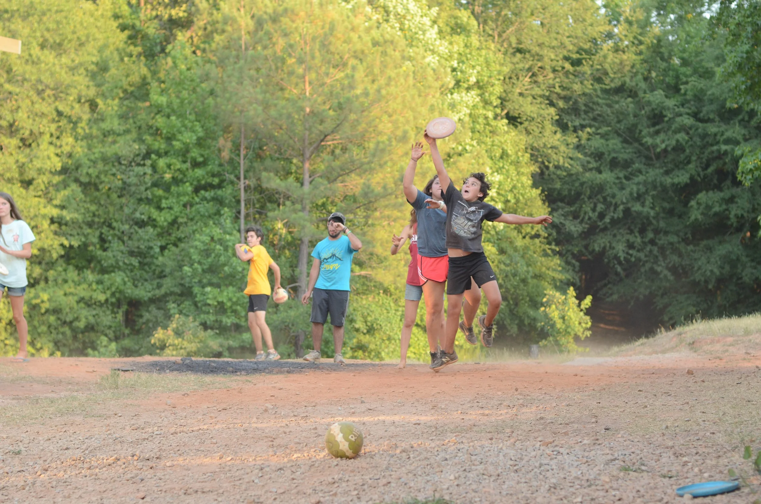 Kid jumping to catch frisbee during ultimate frisbee