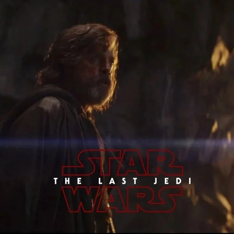 A character from Star Wars: The Last Jedi, with long hair and a beard, in a dark setting with some light reflecting off his face. The text 'STAR WARS THE LAST JEDI' is displayed at the bottom.