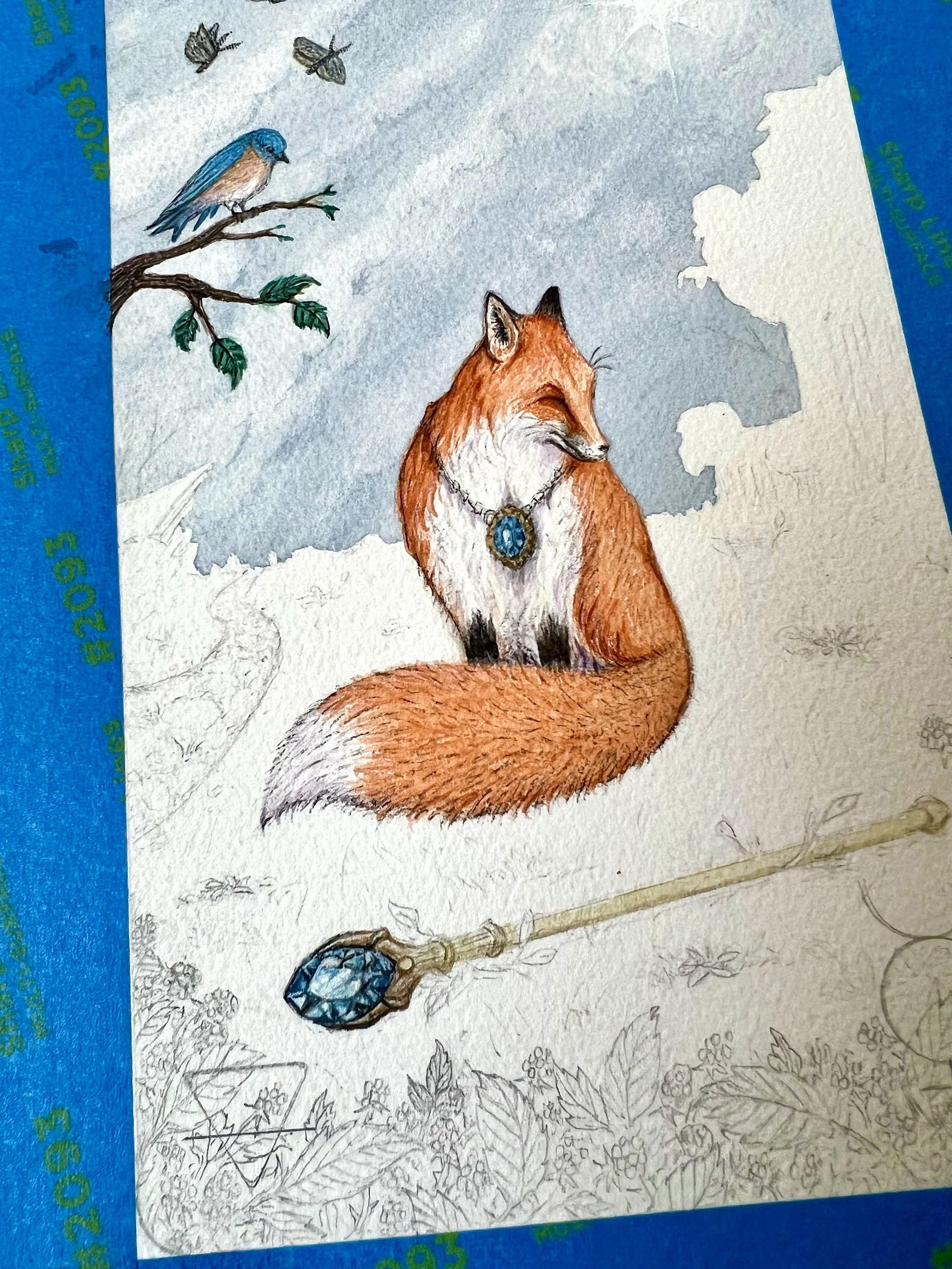 A watercolor painting of a fox wearing a necklace with a blue gemstone, sitting in a woodland scene. There are bluebirds and butterflies in a cloudy sky and a branch with leaves and a blue gemstone hanging from it in the foreground.