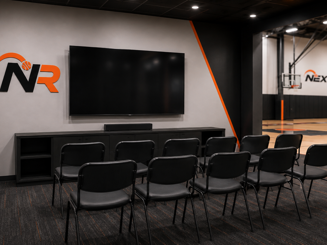 Film room with seating and a large screen for video review at Next Rep Basketball