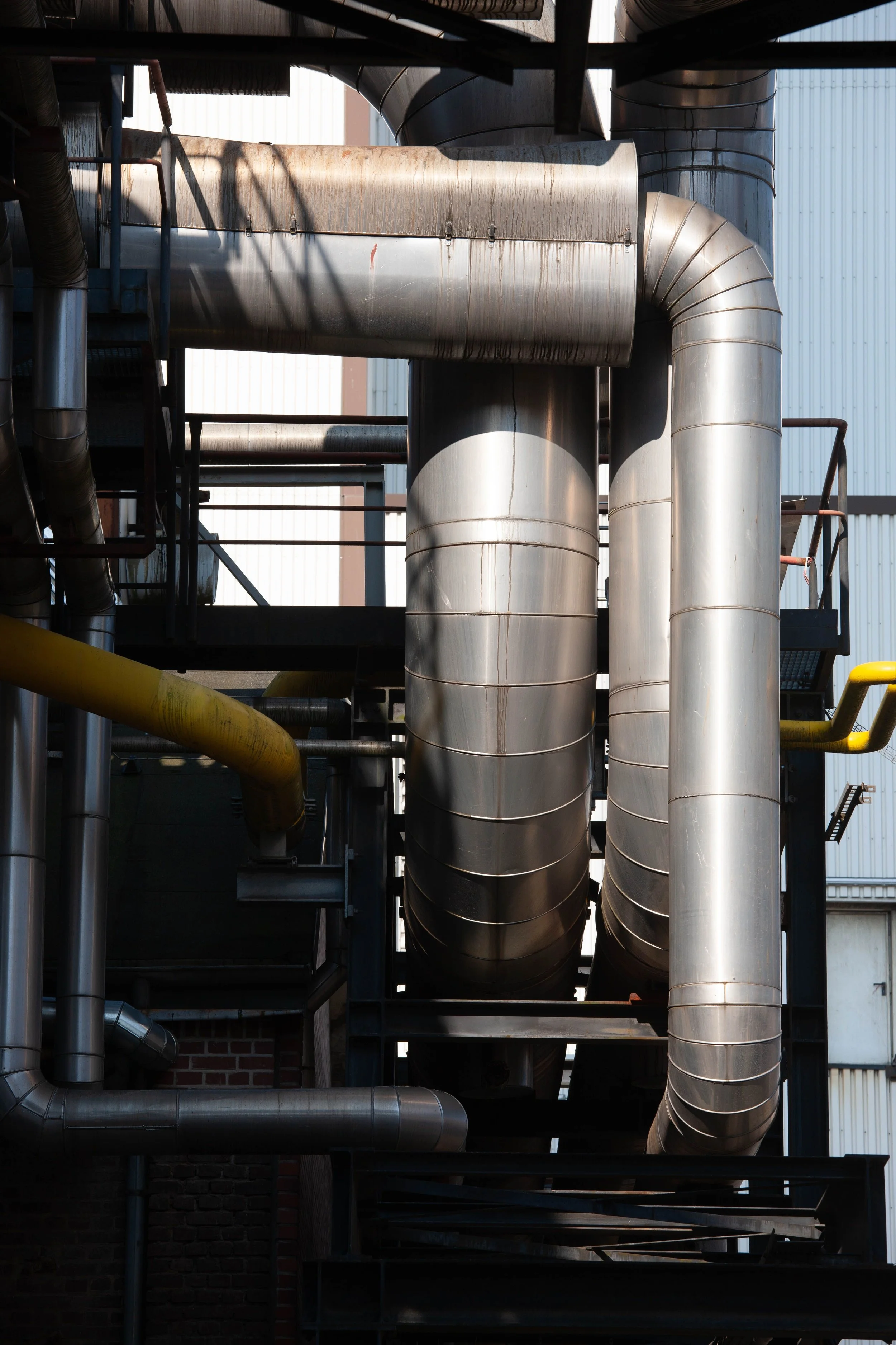 Stainless steel industrial piping and ductwork at a processing facility