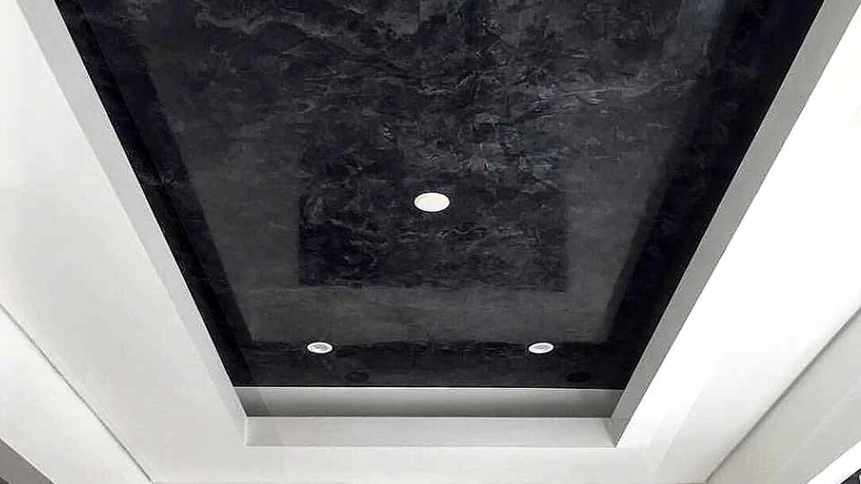 Ceiling with recessed lighting and a black textured grassello margarine high gloss finish.