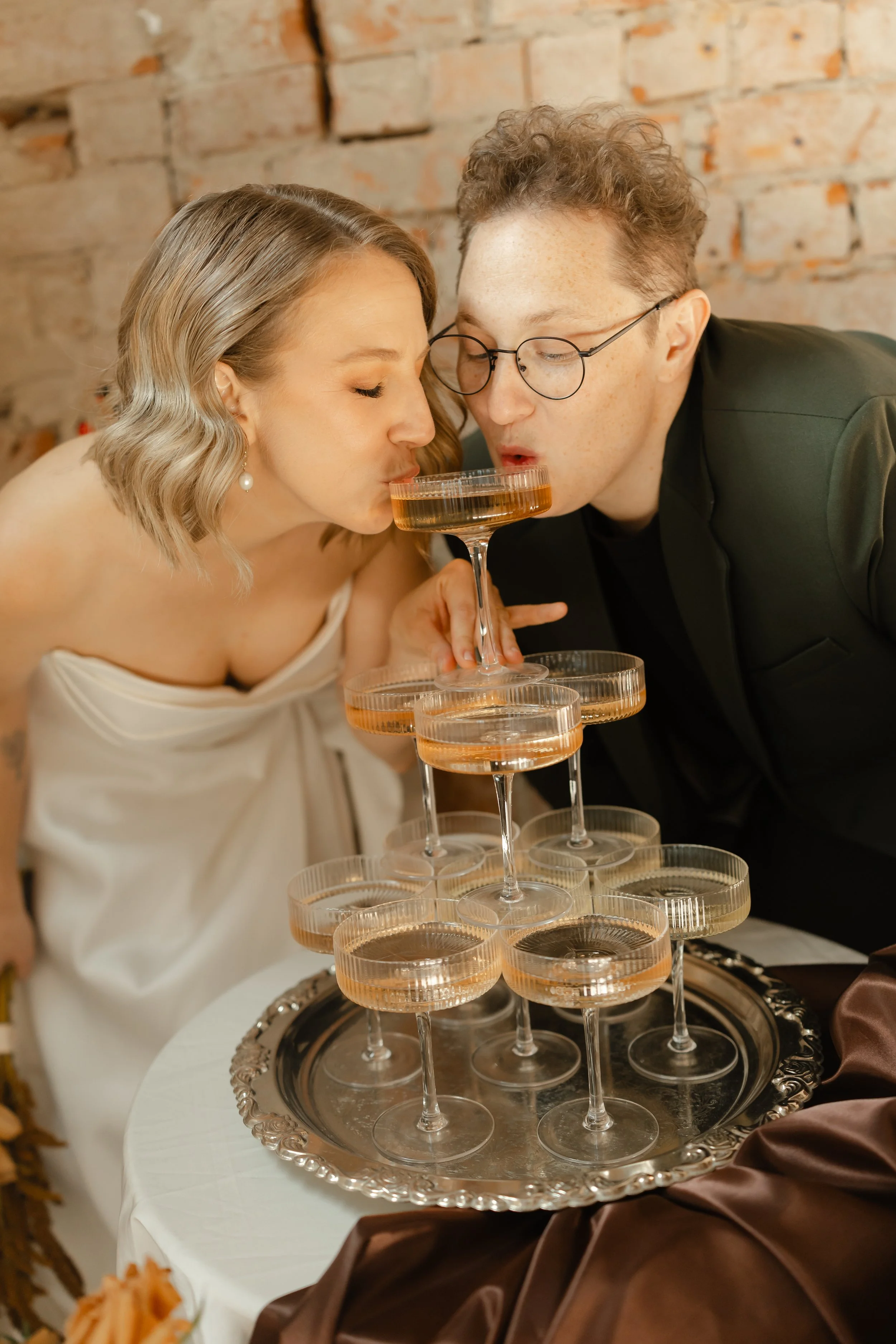 Newlyweds celebrating with champagne at a luxury Adelaide hotel after their wedding ceremony.