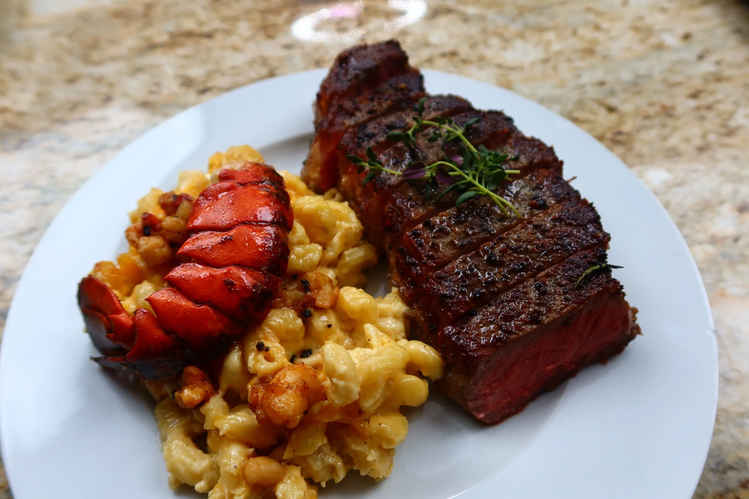 Plated lobster tail with herb-roasted beef and mac and cheese by Chef Kaye - Dallas private fine dining and corporate catering by The Culinary Gallery