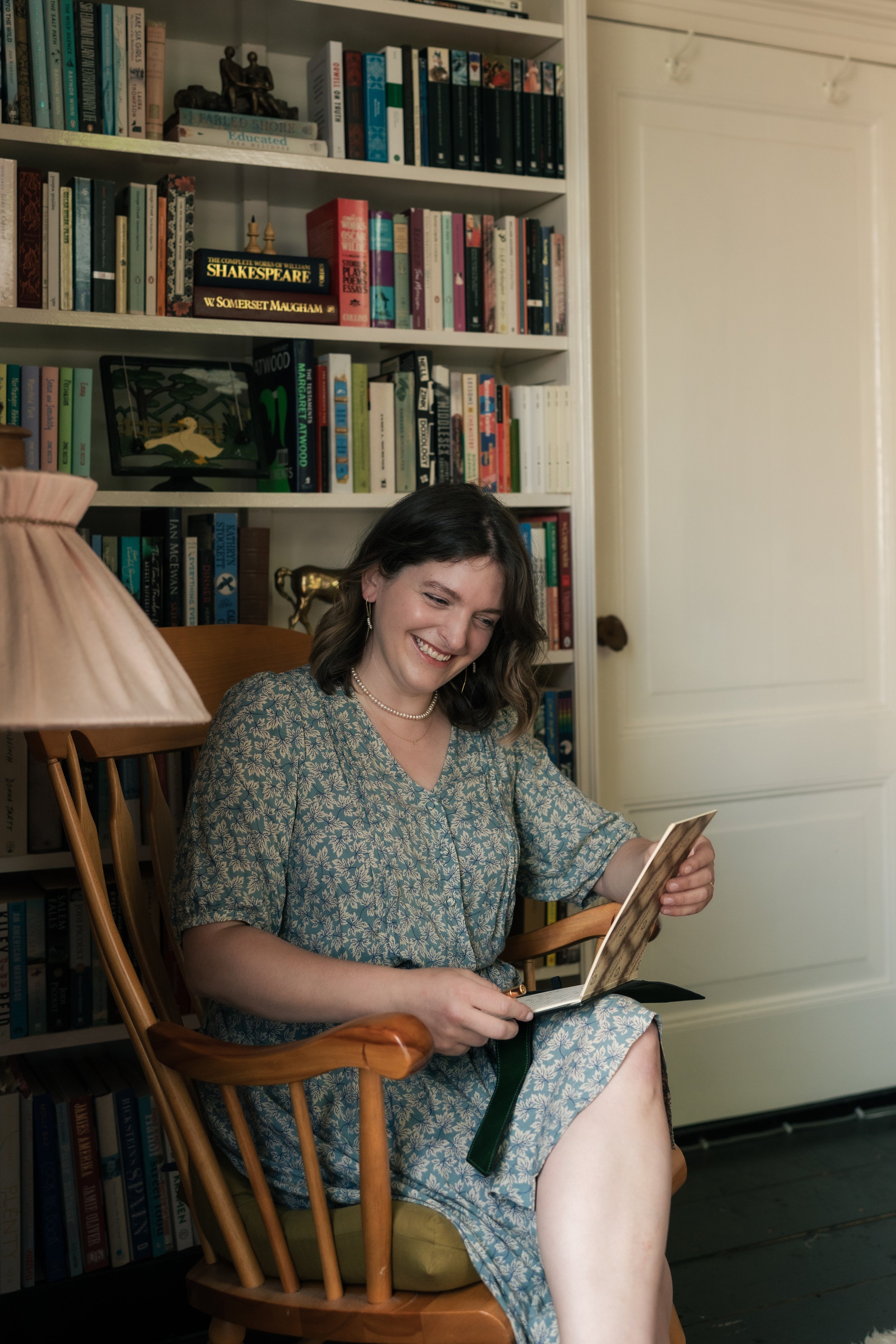 Nora Keller sitting in her library, reviewing her notes.