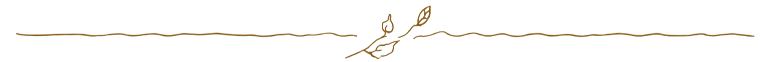 Close-up of a golden twig ornament with detailed engravings.