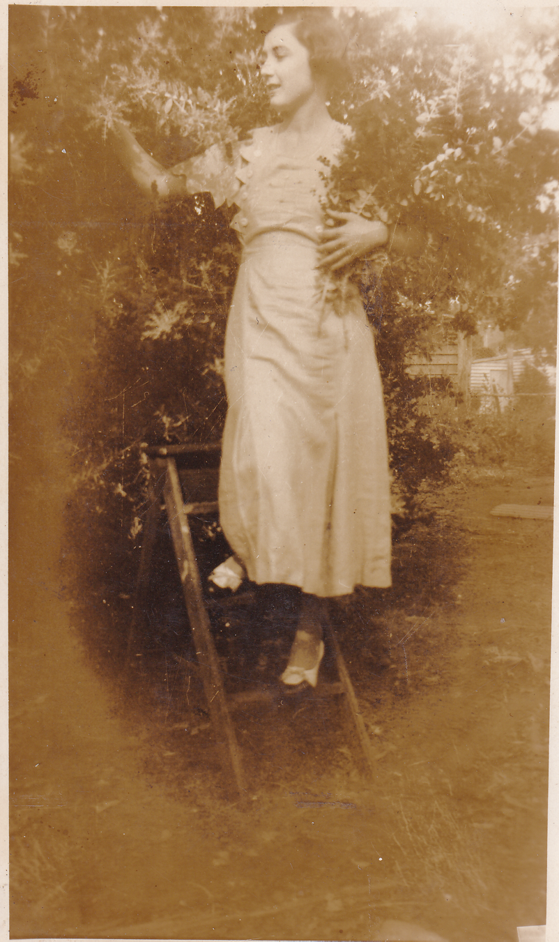 Veronica Baker (Girlie Baker) up a ladder, probably in Bauple