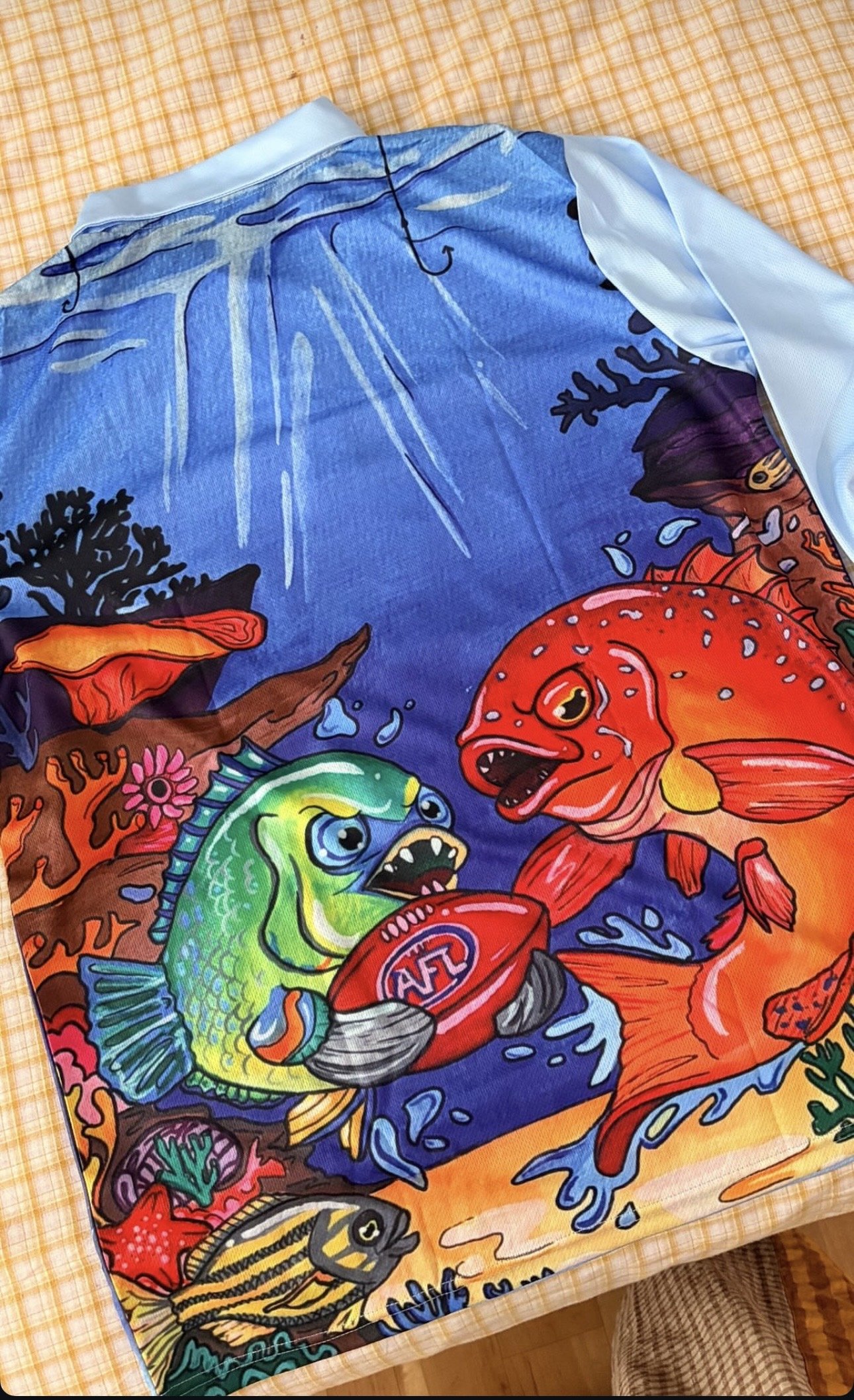 Colorful, cartoon-style illustration of fierce fish fighting in an ocean scene, with a stage-like background.