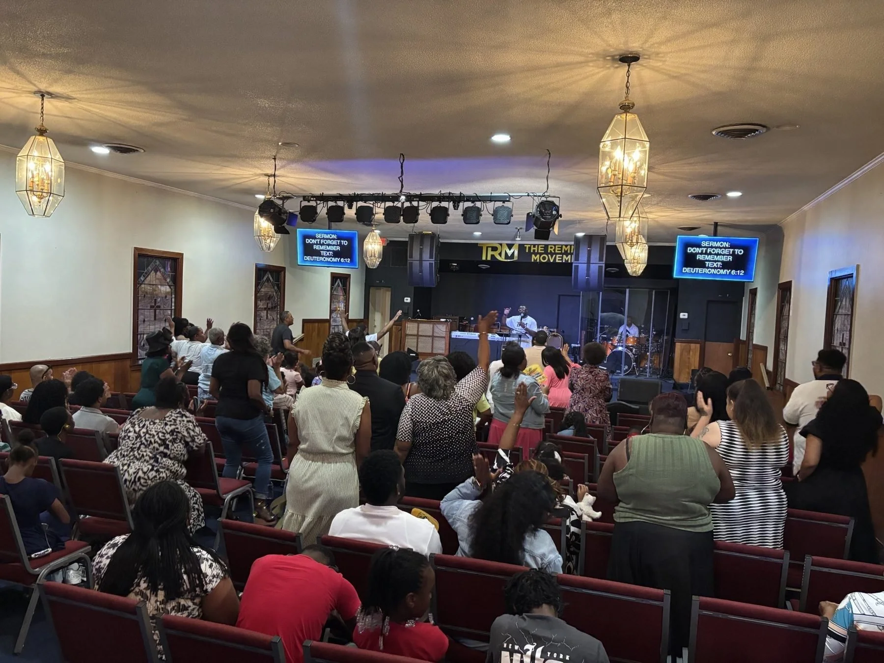 Congregation worshiping during Sunday service at The Remnant Movement