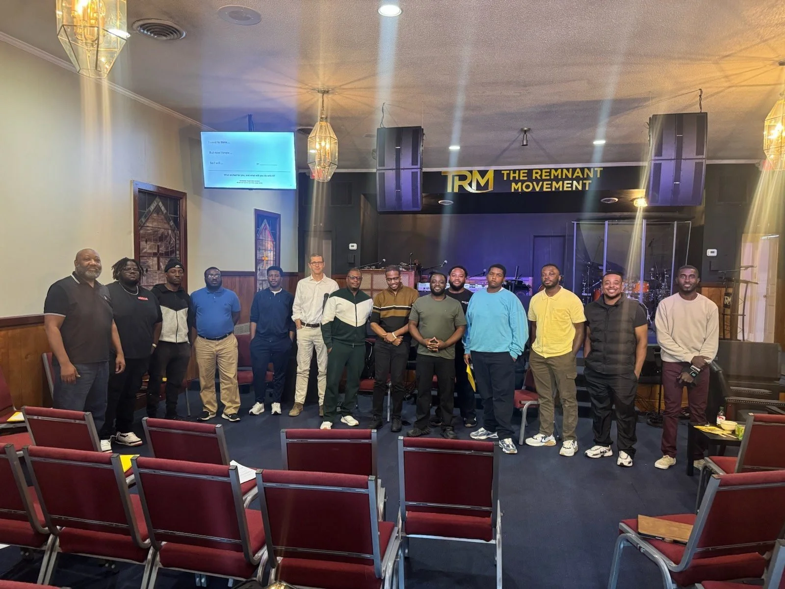 Men's fellowship group photo in the sanctuary at The Remnant Movement